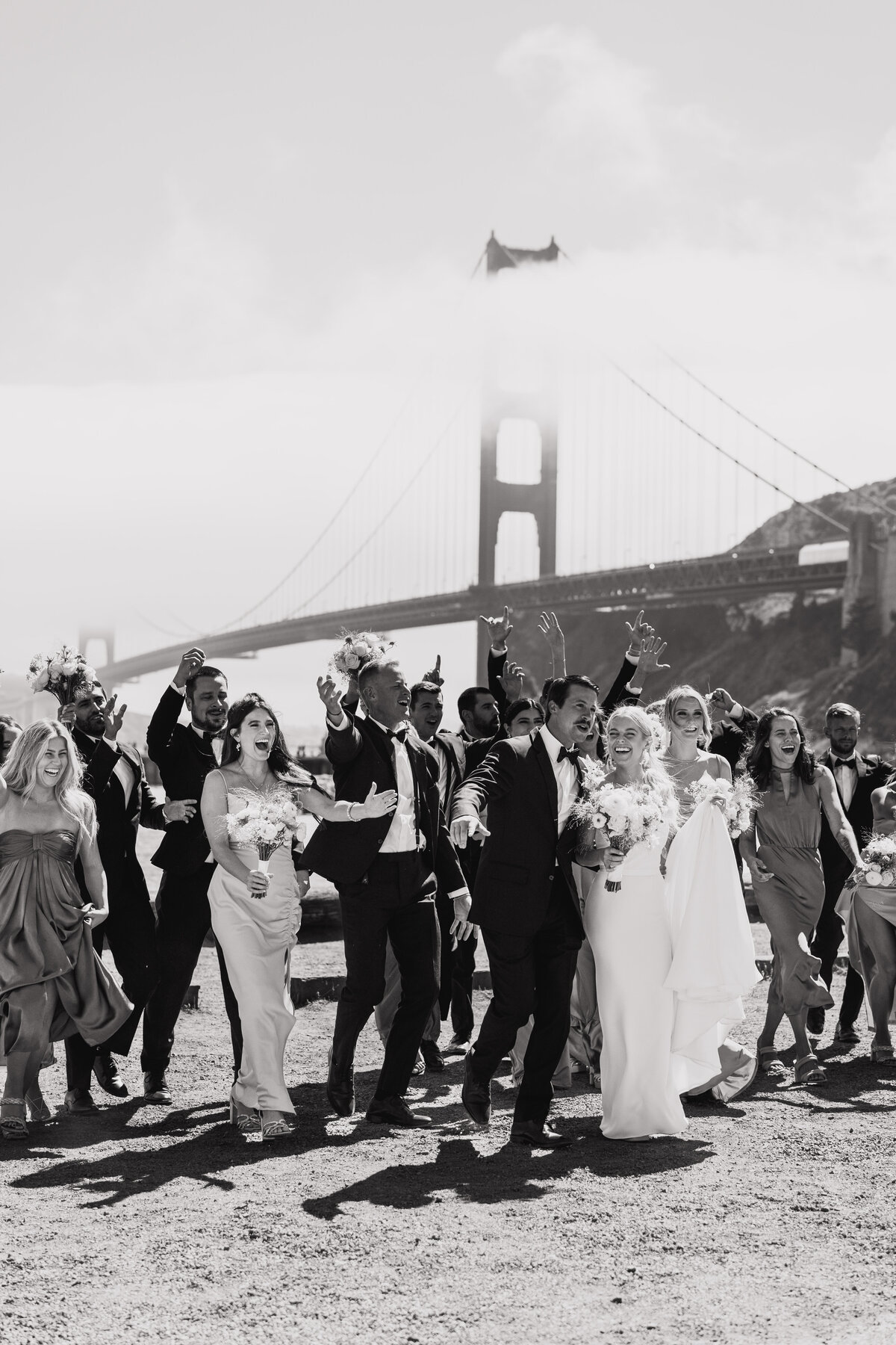 wedding bridal party walking under golden gate bridge