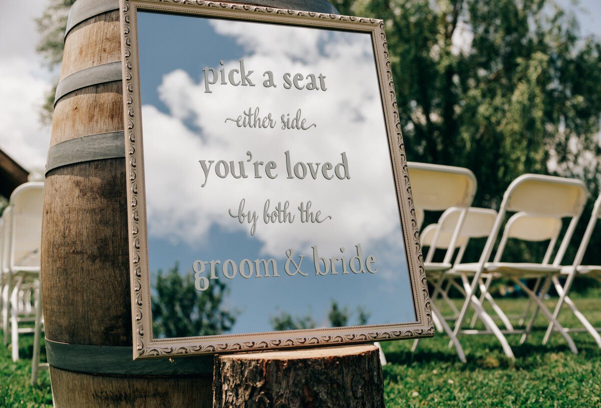 Elegant mirror welcome sign for outdoor wedding ceremony