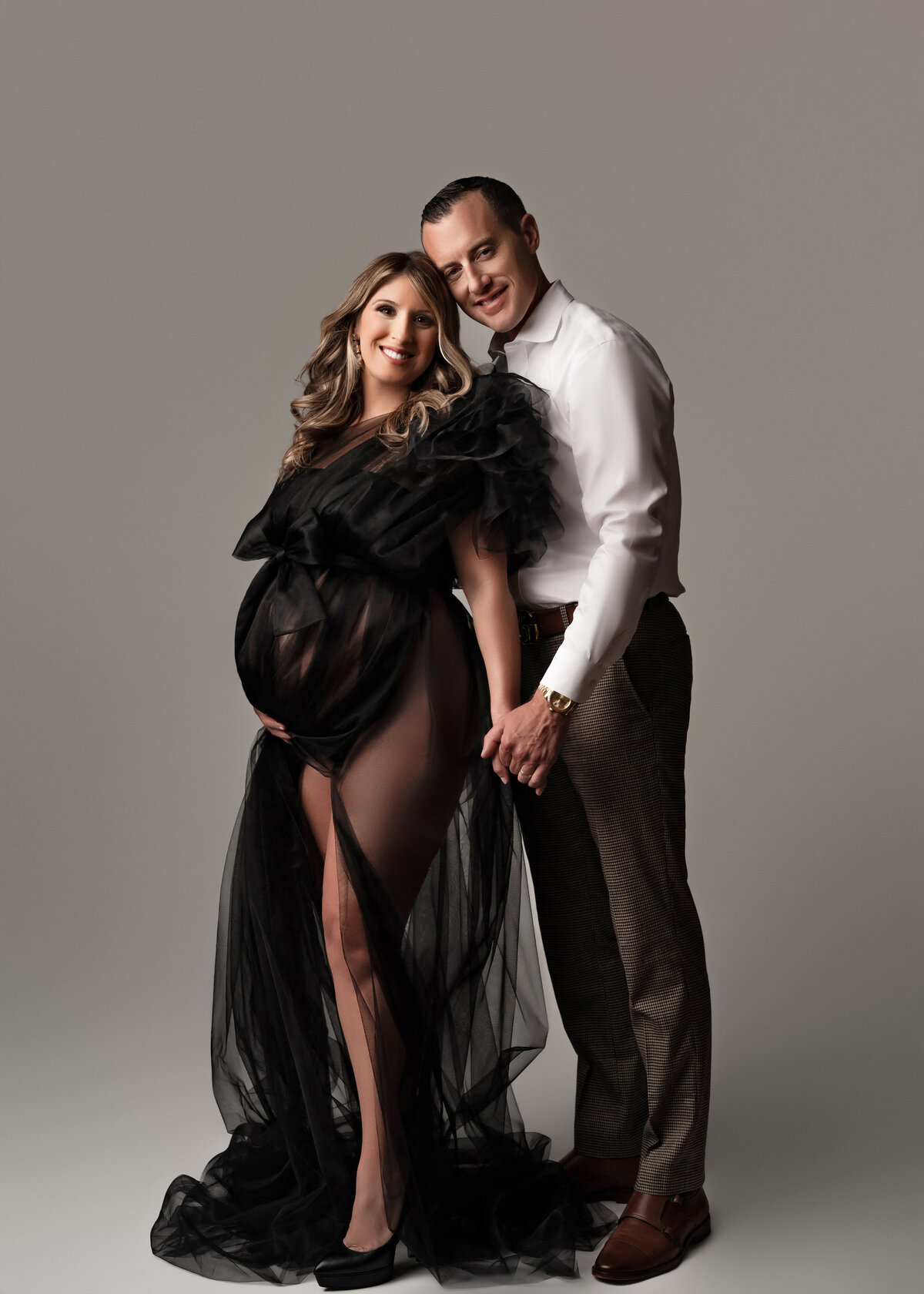 dressed to impress for high end maternity portraiture in oswego studio heels and see through gown