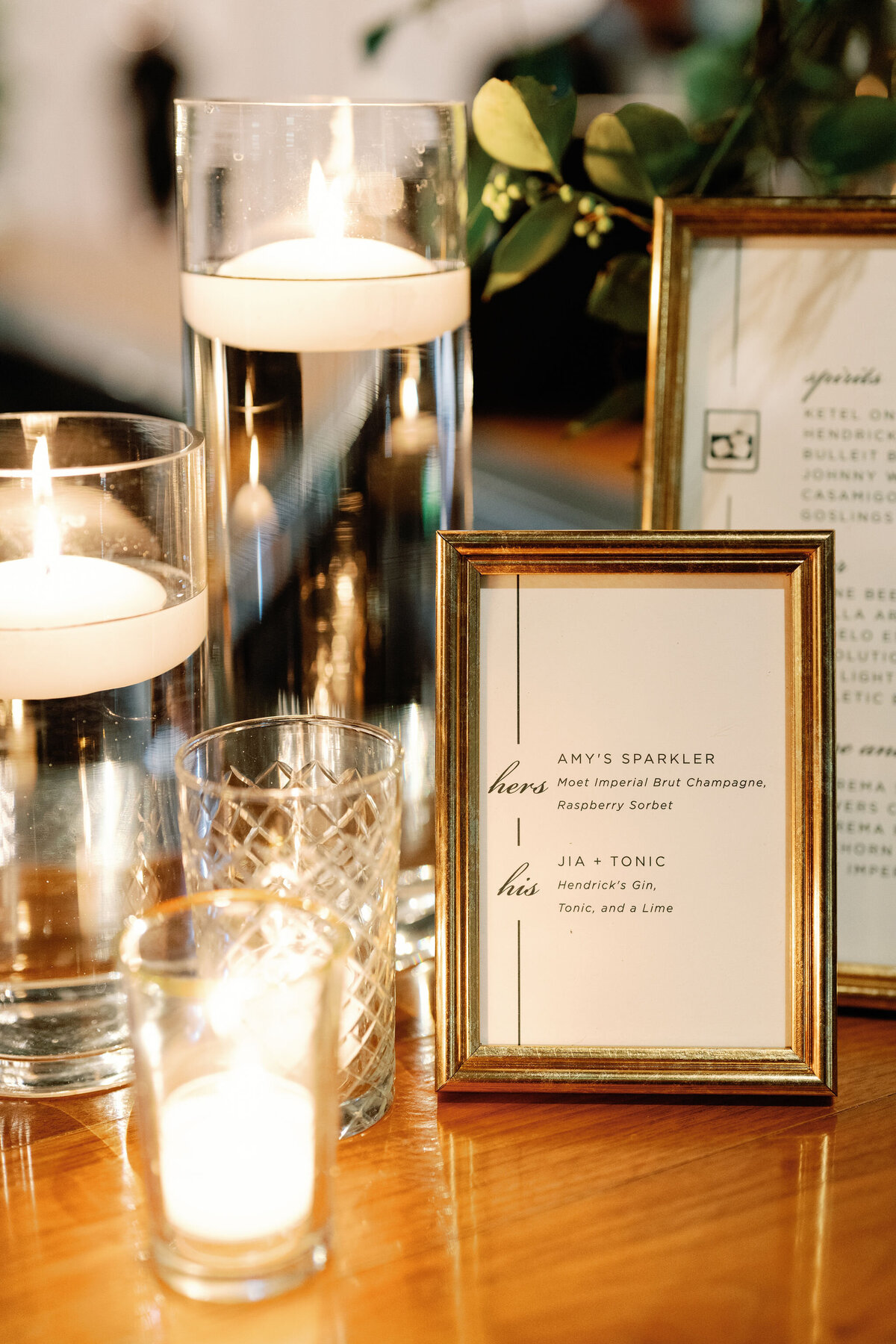 A close up of a framed menu of the wedding signature cocktails. 