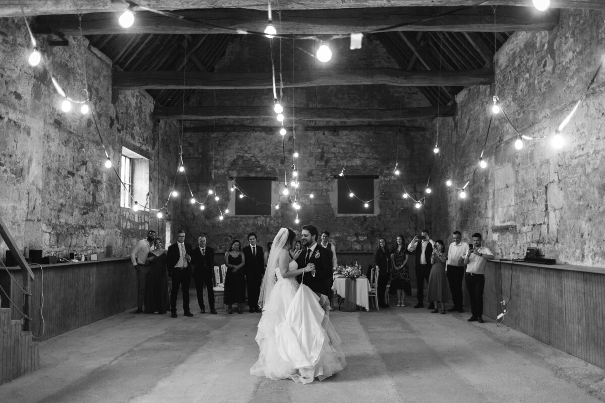 black and white photo of couple dancing on thier wedding day