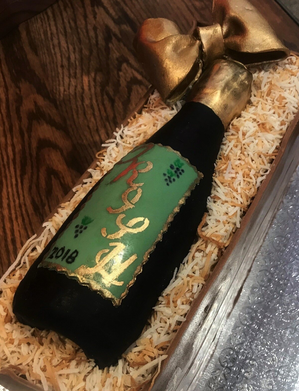 Edible wine bottle with decorative label in woodgrain wine box cake