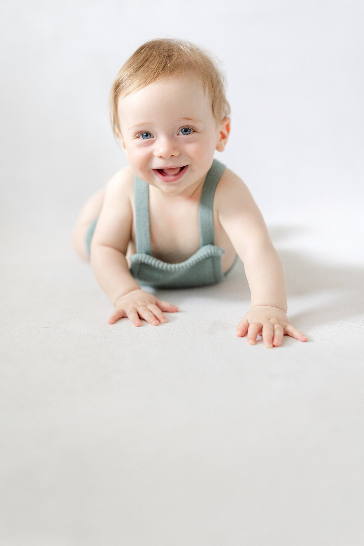 Tampa 6-month milestone portrait of smiling baby boy in natural light studio