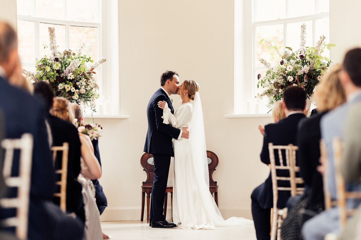 Bride and groom kiss at Iscoyd Park- The Garden Room