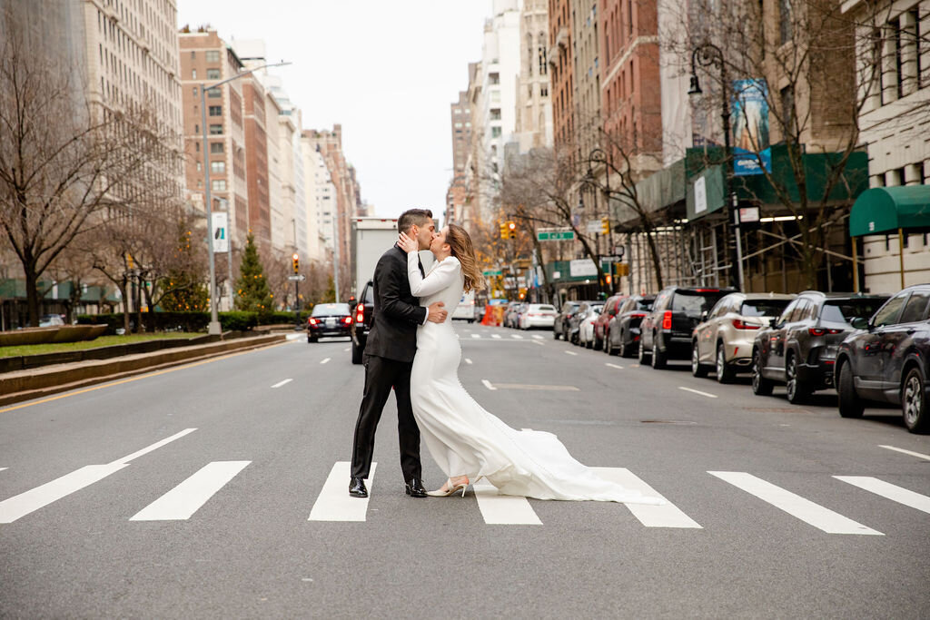erica-renee-beauty-nyc-wedding-harold-pratt-house-tuxedo-gown-plunging-neckline-clean-beauty-wedding-hair-and-makeup-duo-team-high-end-nyc-bride-cool-hospitality-medium-length-hairstyle-city-street-crosswalk-nyc-couple