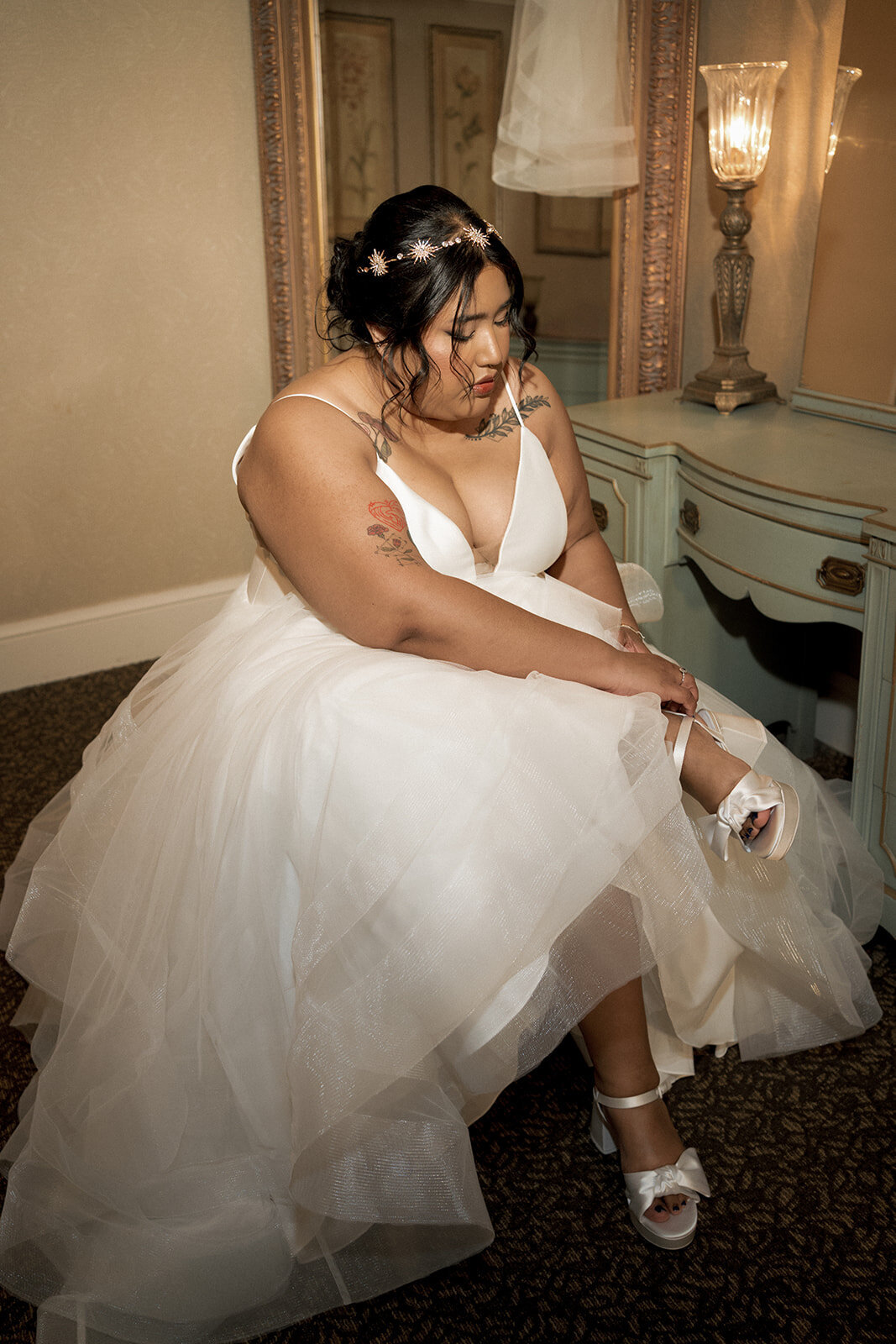 bride puts on wedding shoes getting ready