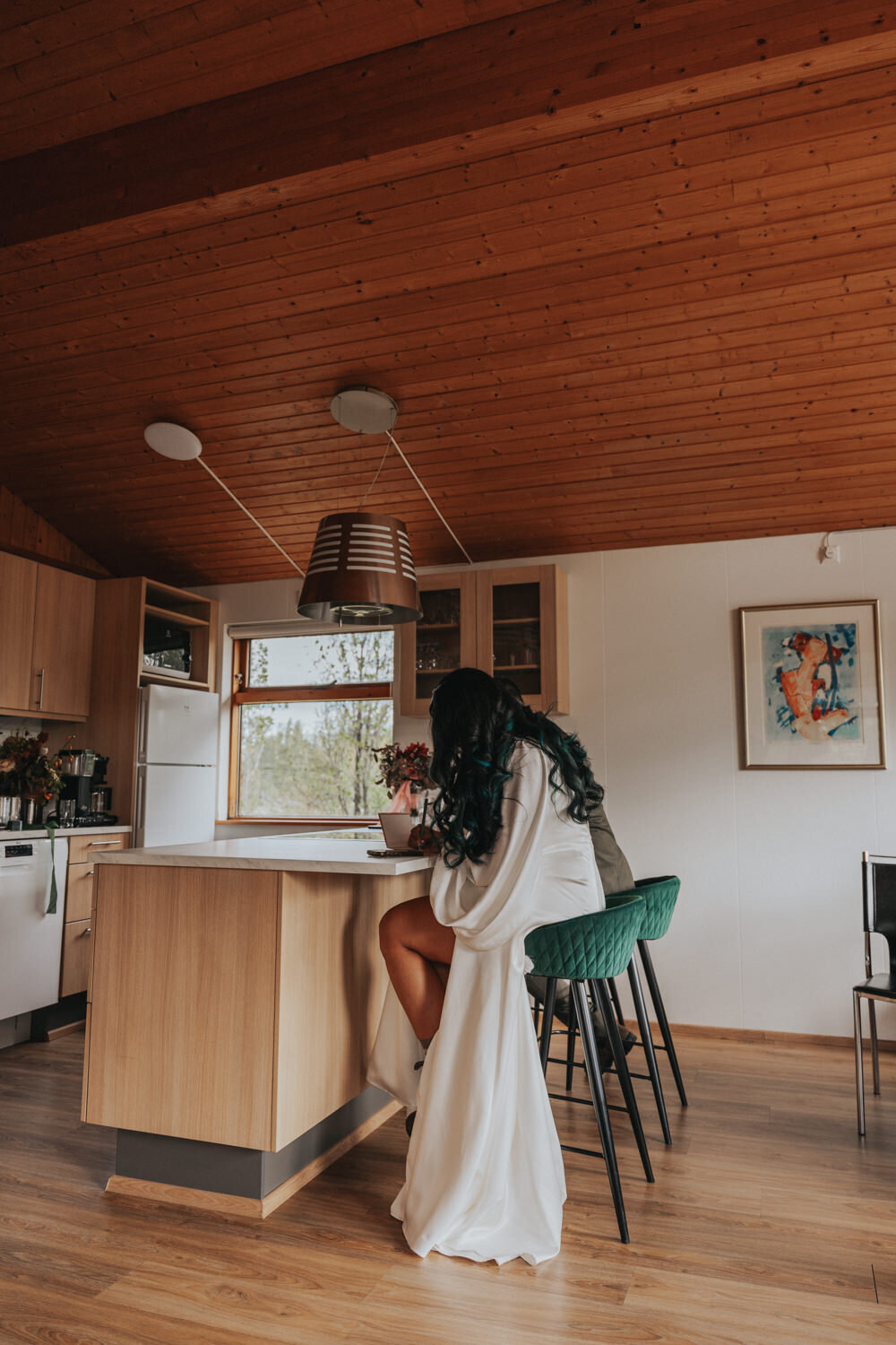 Husband and wife sit at the bar of an Iceland cottage 
