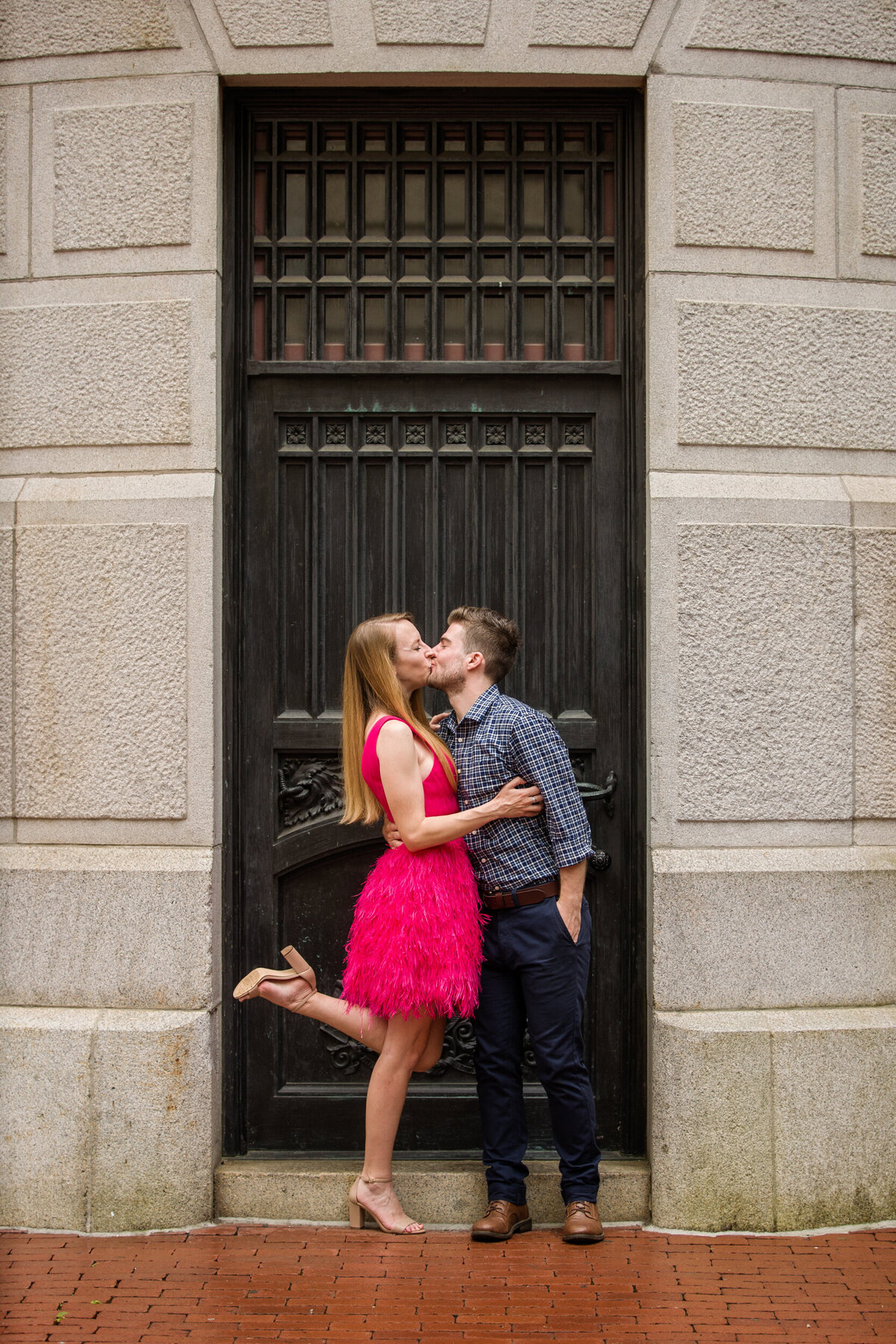 Romantic engagement photo of a couple posing under the elegant architecture of Philadelphia City Hall, celebrating their love with the city's historic charm as a backdrop.