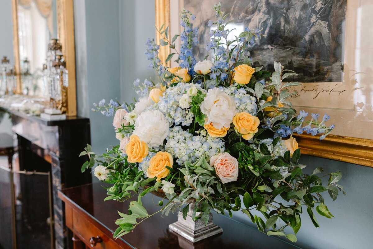 Yellow and blue floral display at Farmington Country Club wedding