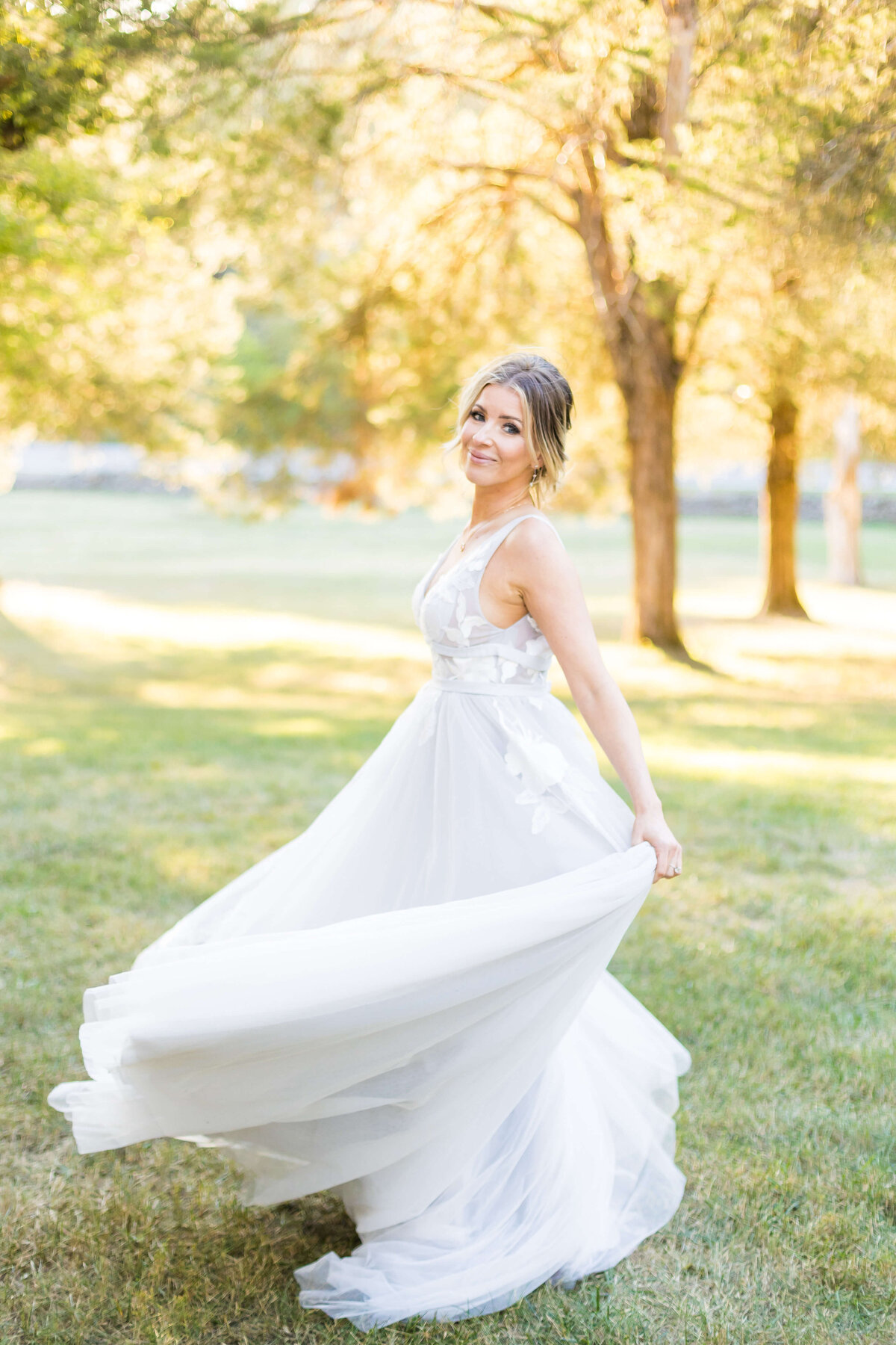 Bride swirling around in a park