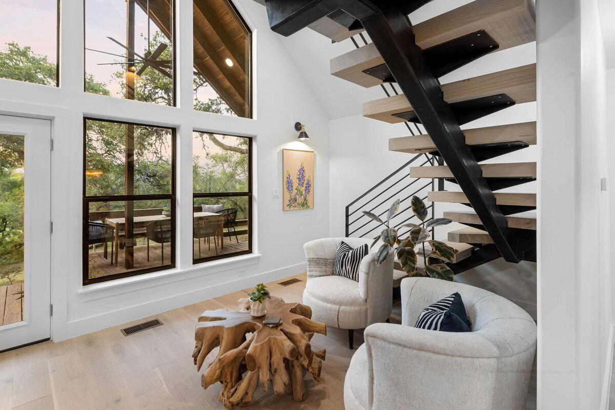 Stairs beside large bay windows in Texas home