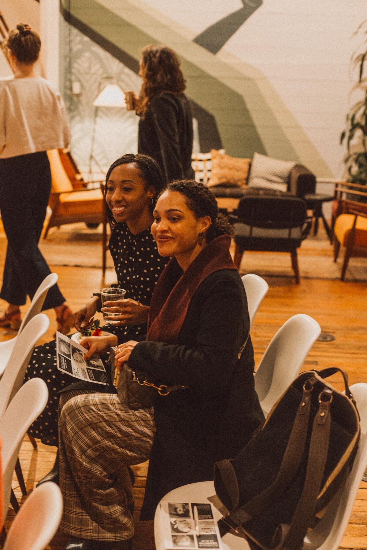 Two participants at a Black Her Stories event are posing and taking a picture together