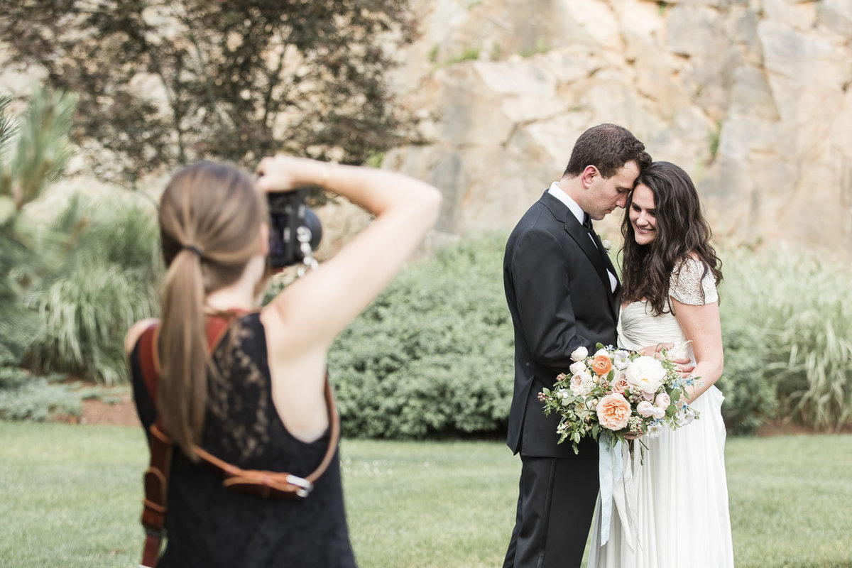 Woman taking picture of couple