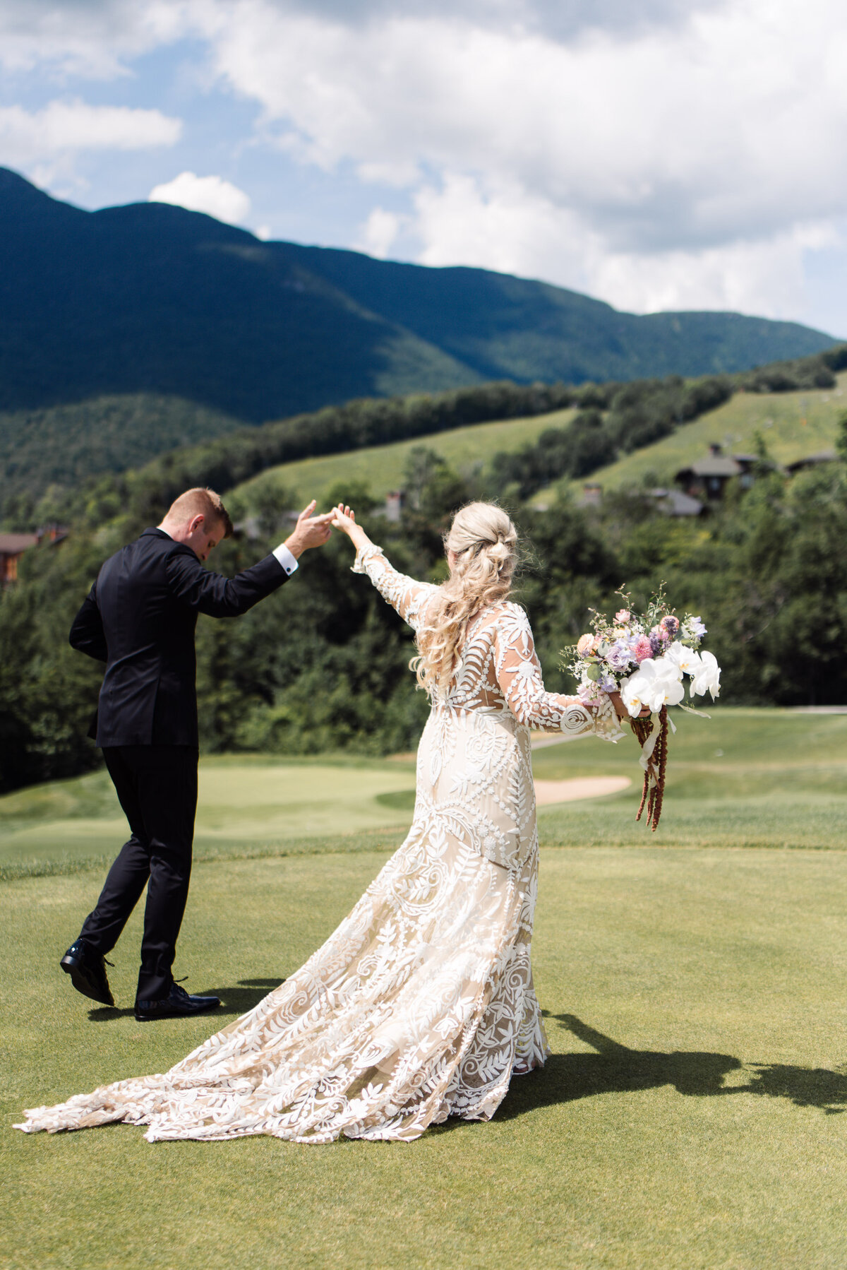 Groom leads bride by hand across golf course at spruce speak wedding