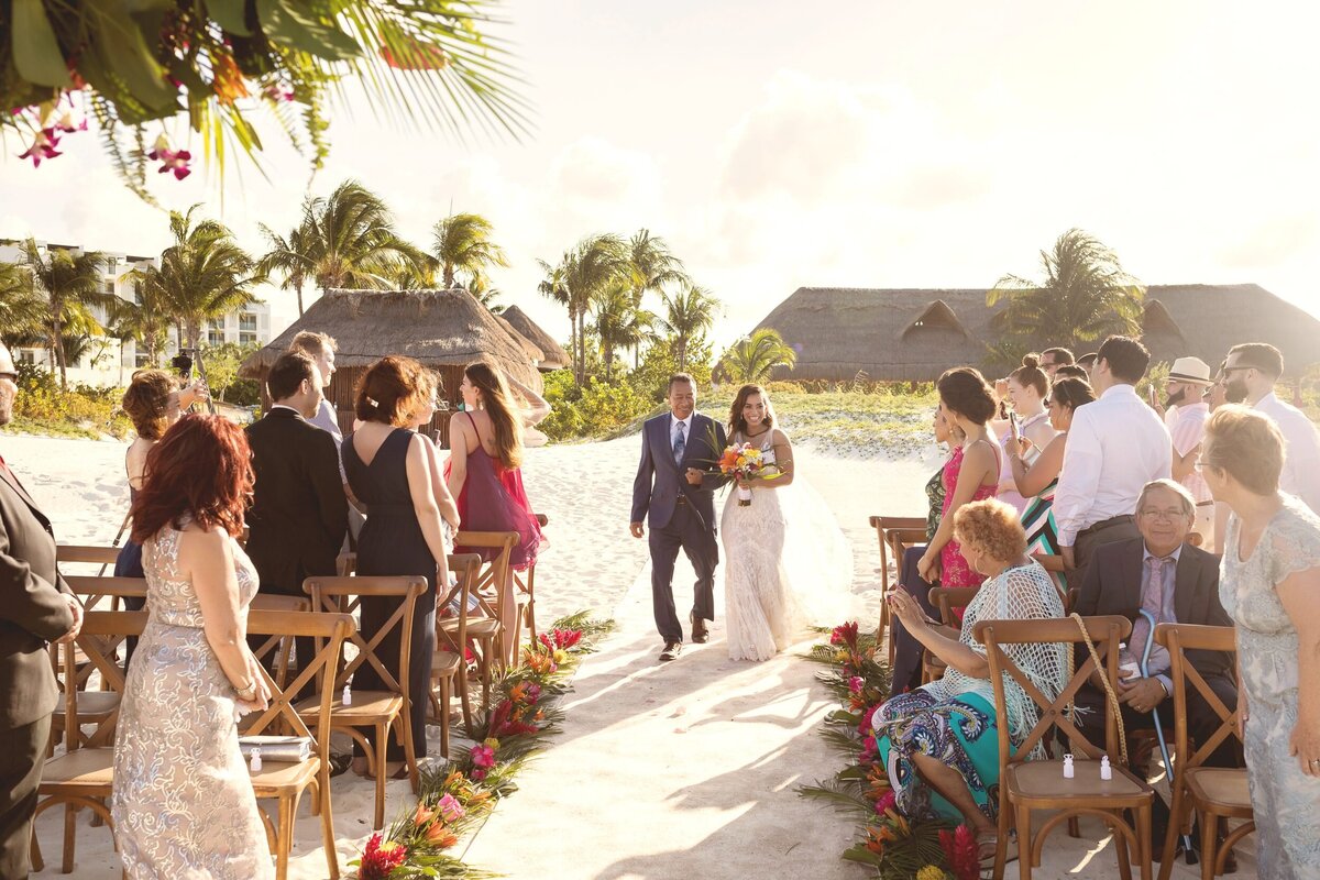 Bride walking down aisle at beach wedding in Cancun
