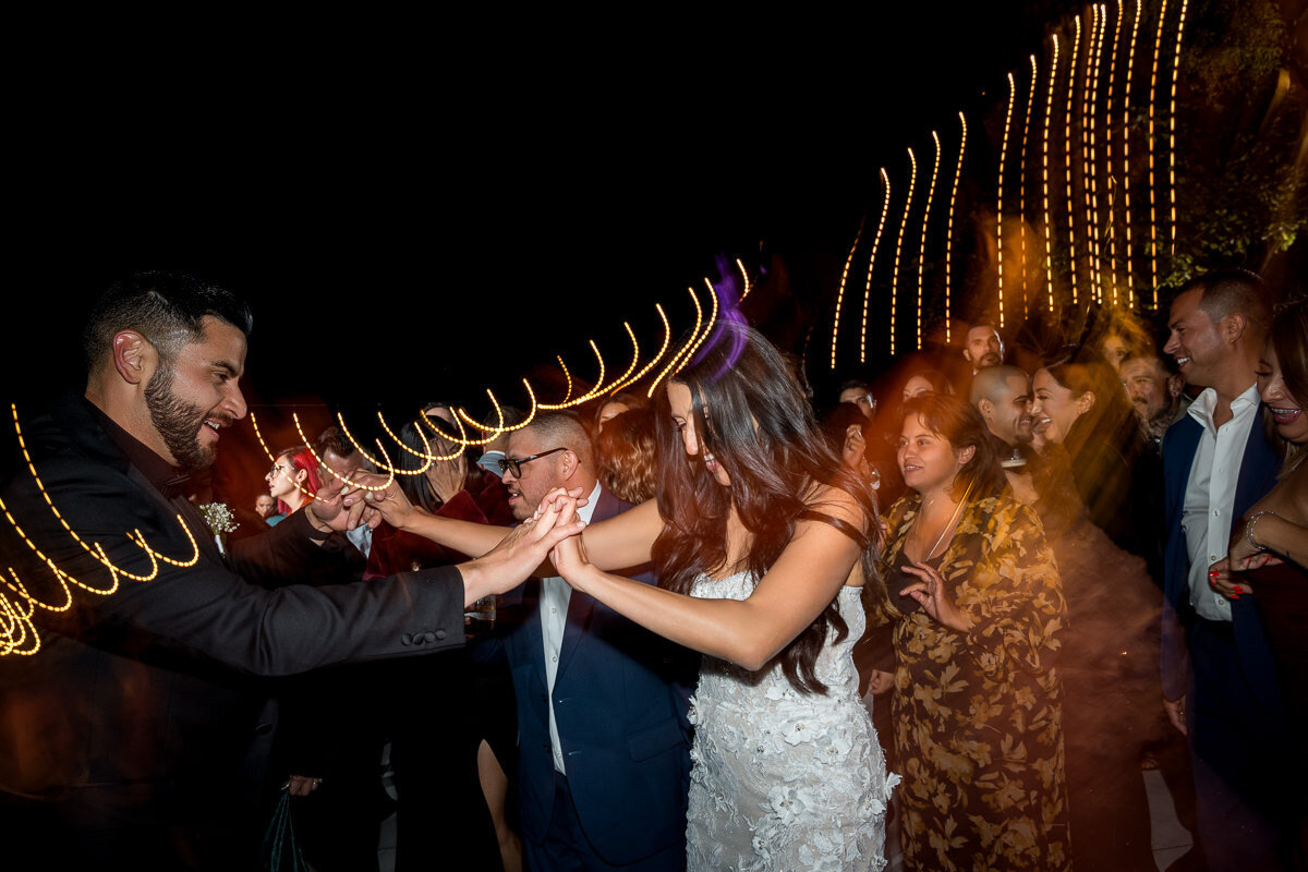 A heartfelt moment as a bride and groom share their first dance during their reception at Airola Road Vineyard, surrounded by the warm glow of lights and the beauty of Northern California wine country.