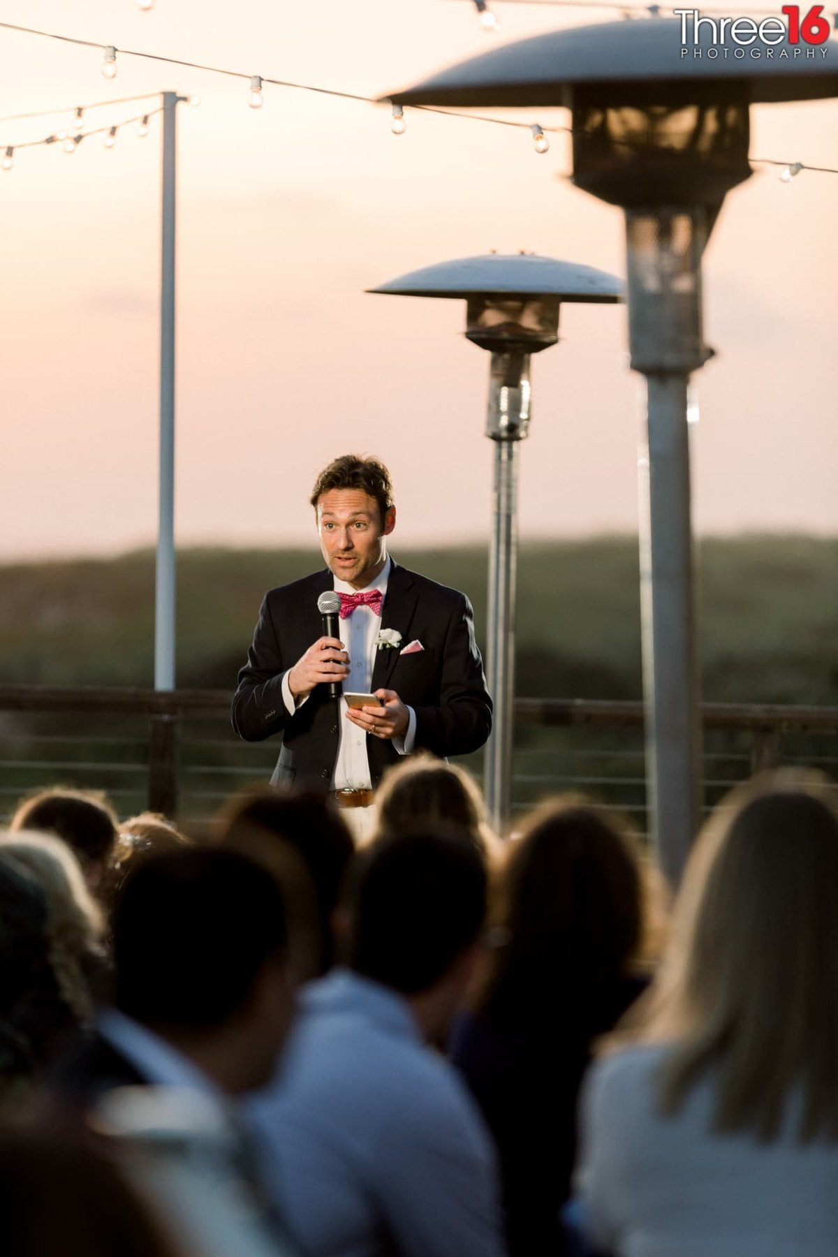 Best Man toasts amongst the heat lamps