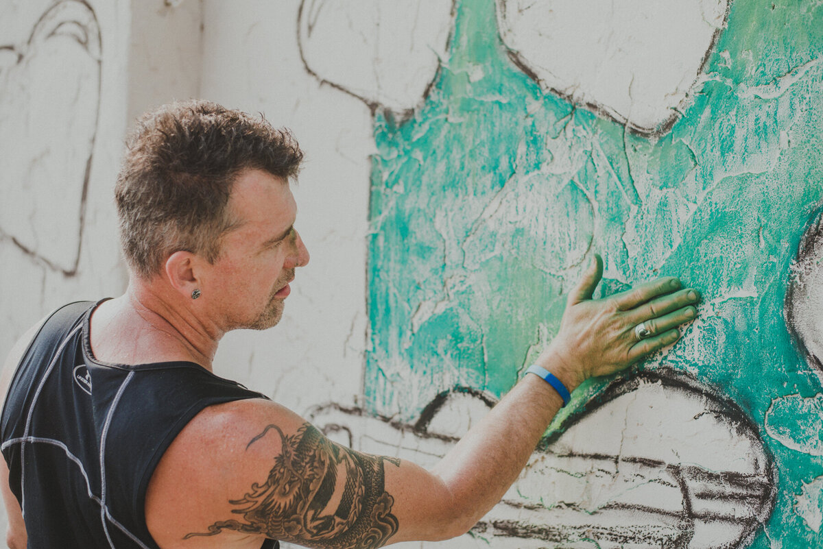 man makes chalk mural on side of building in cuyahoga falls