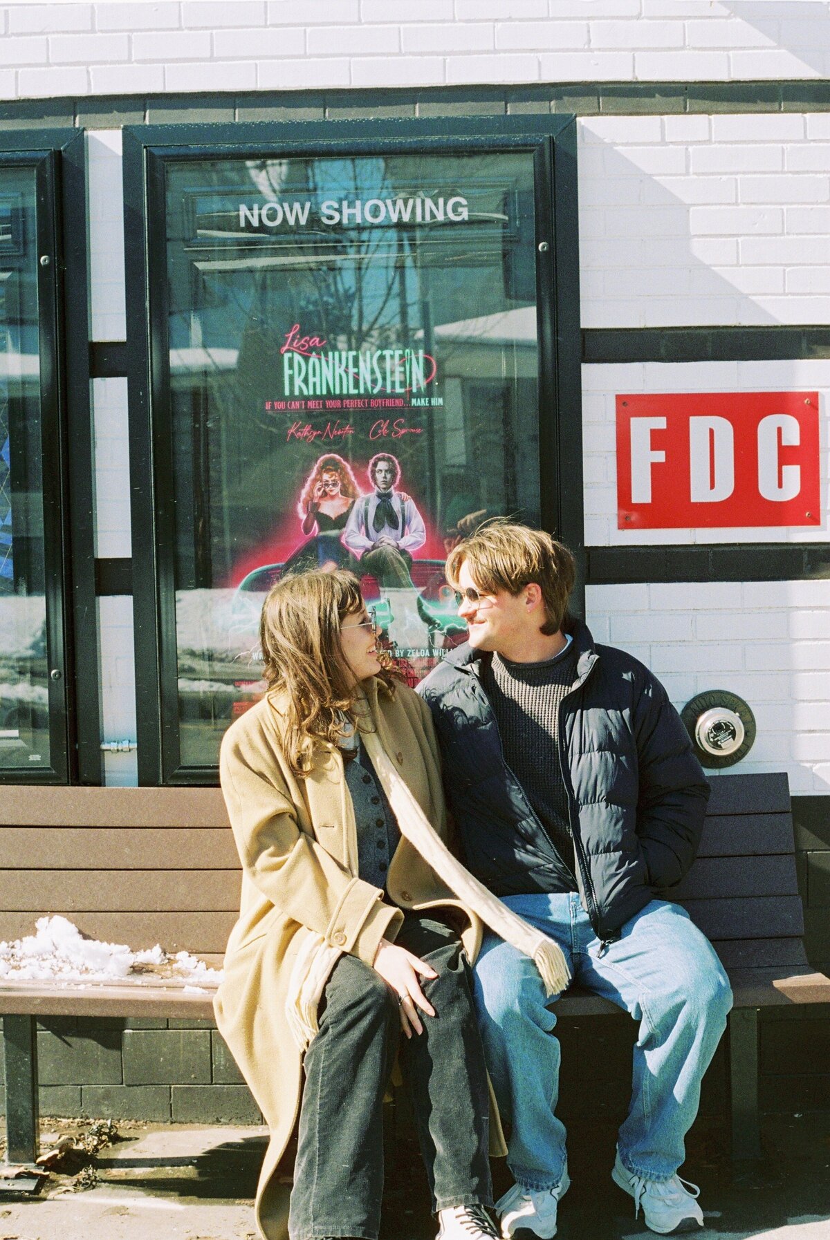 candid photography, couple sitting on public city bench