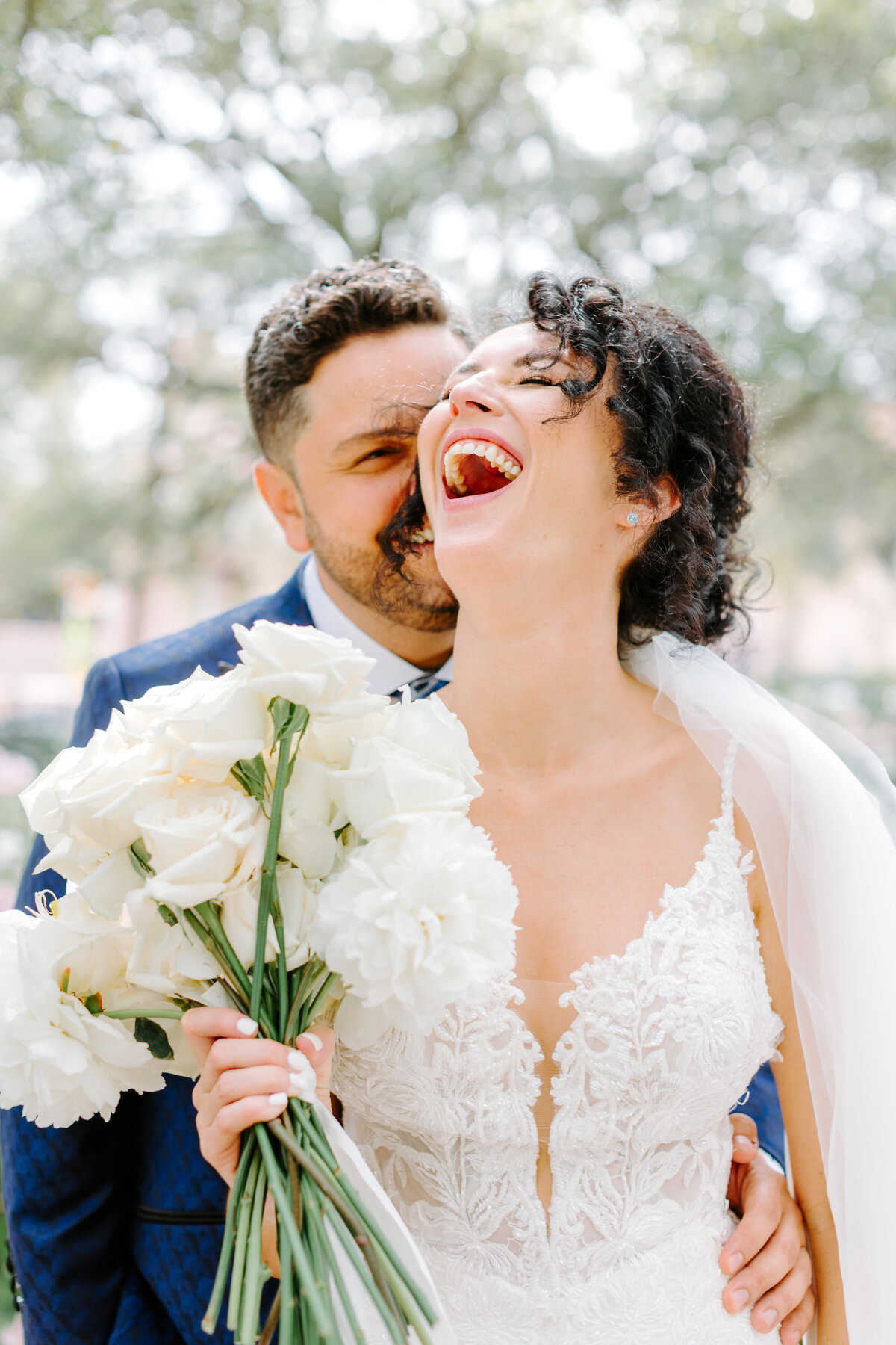 bride and groom candidly laughing during portraits