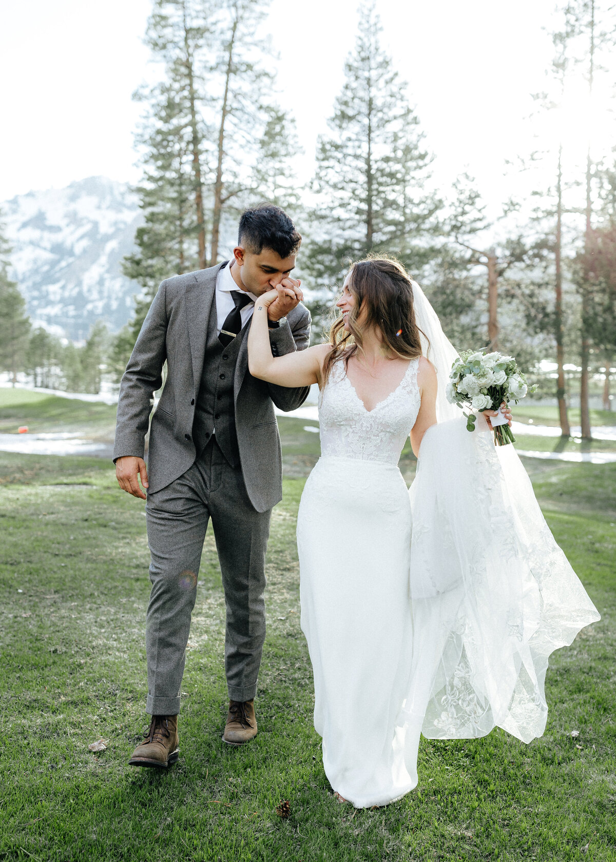 Wedding & Elopement Photogrpahy, bride and groom walking in a large grassy field
