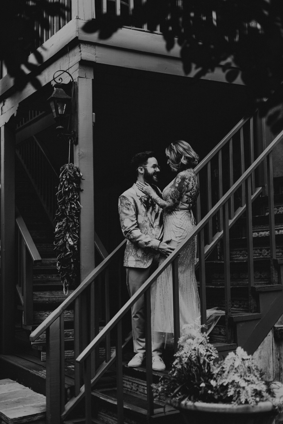 bride and groom standing on stairs together in Santa Fe