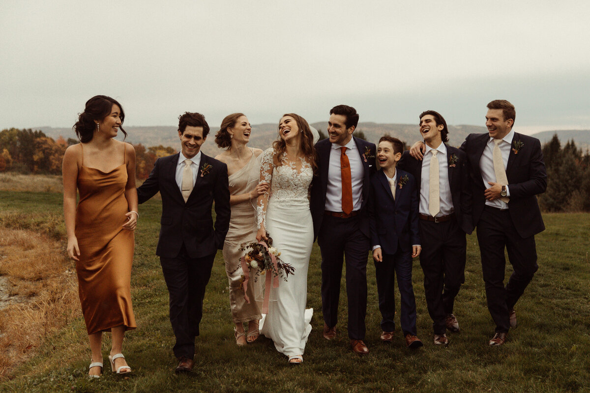 Bridal Party walking, dressed in a fall color palette at Wrens Roost Barn