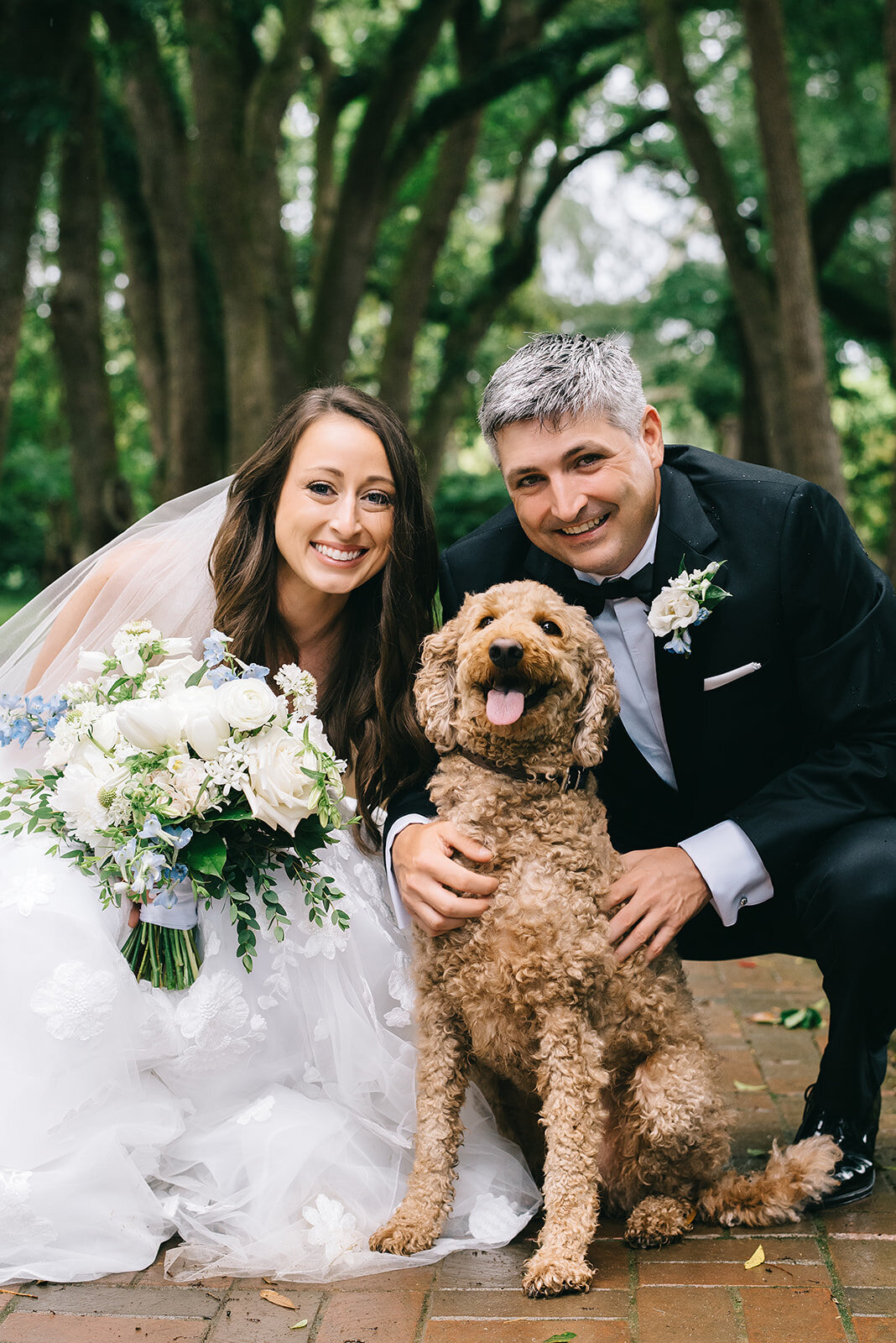 Bride and groom and their dog with white and blue bouquet designed by Abby Grace Florals at Greenville SC wedding