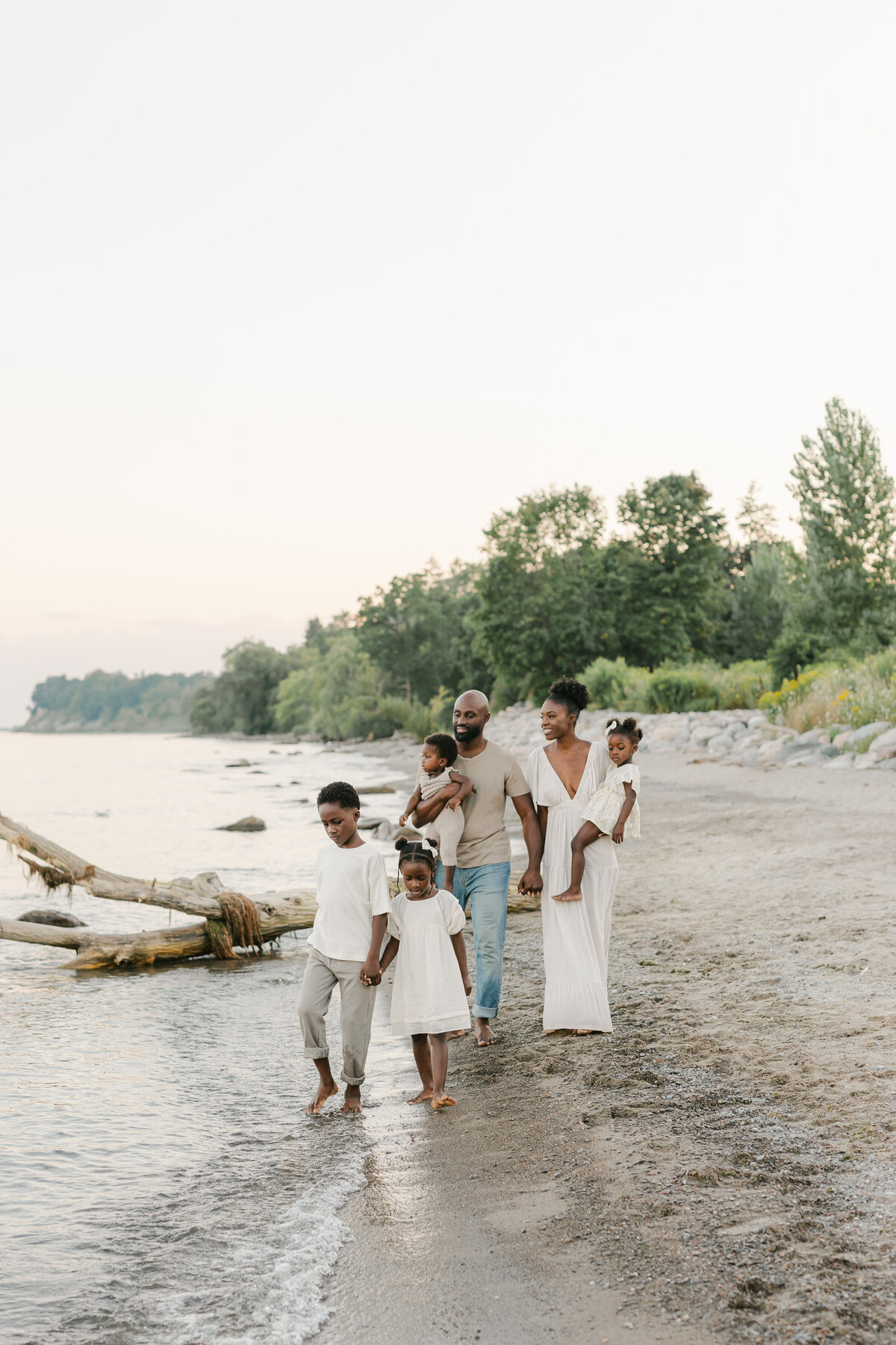 A family with four children walking on the beach in Toronto