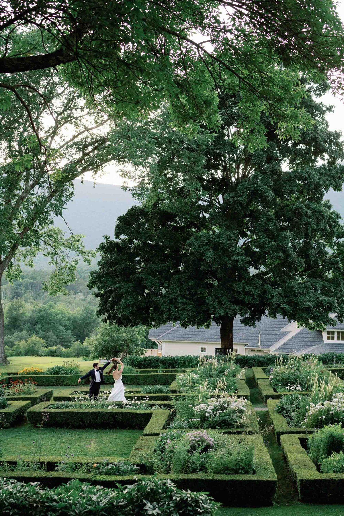 bride and groom dance through the gardens at hildene wedding in manchster, vt