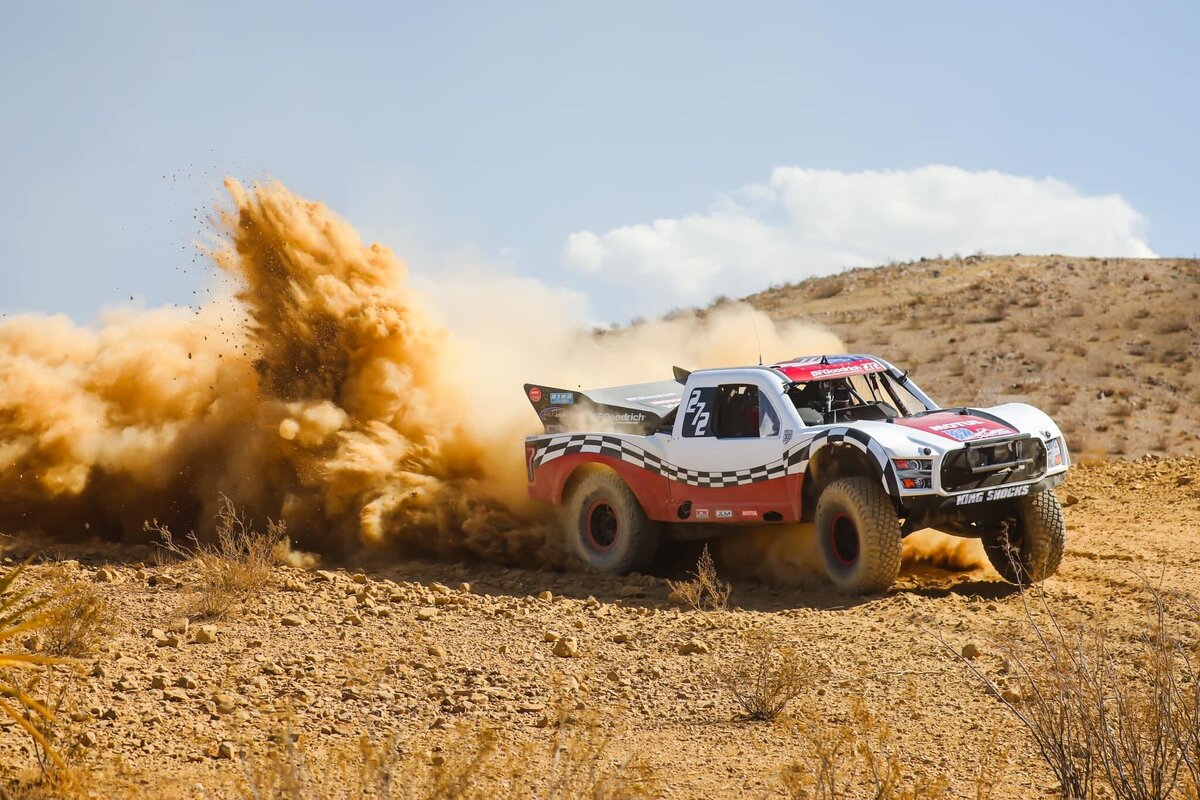 off roading vehicle driving through dirt