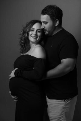 Professional maternity portrait by St Augustine maternity photographers showing expecting couple in elegant black and white studio session