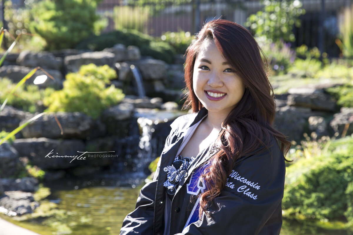 Smiling sorority girl in front of waterfall and pond