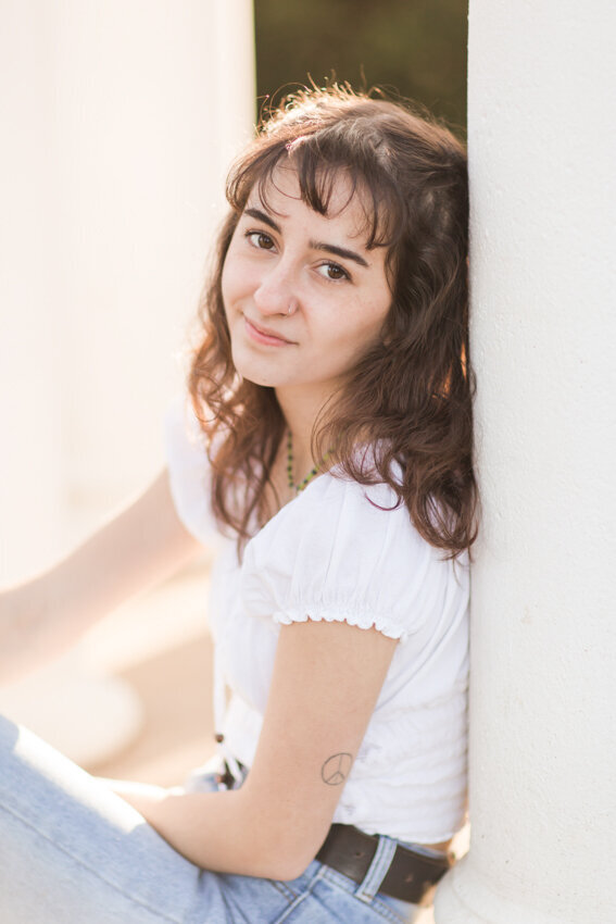 teen leaning against pillar