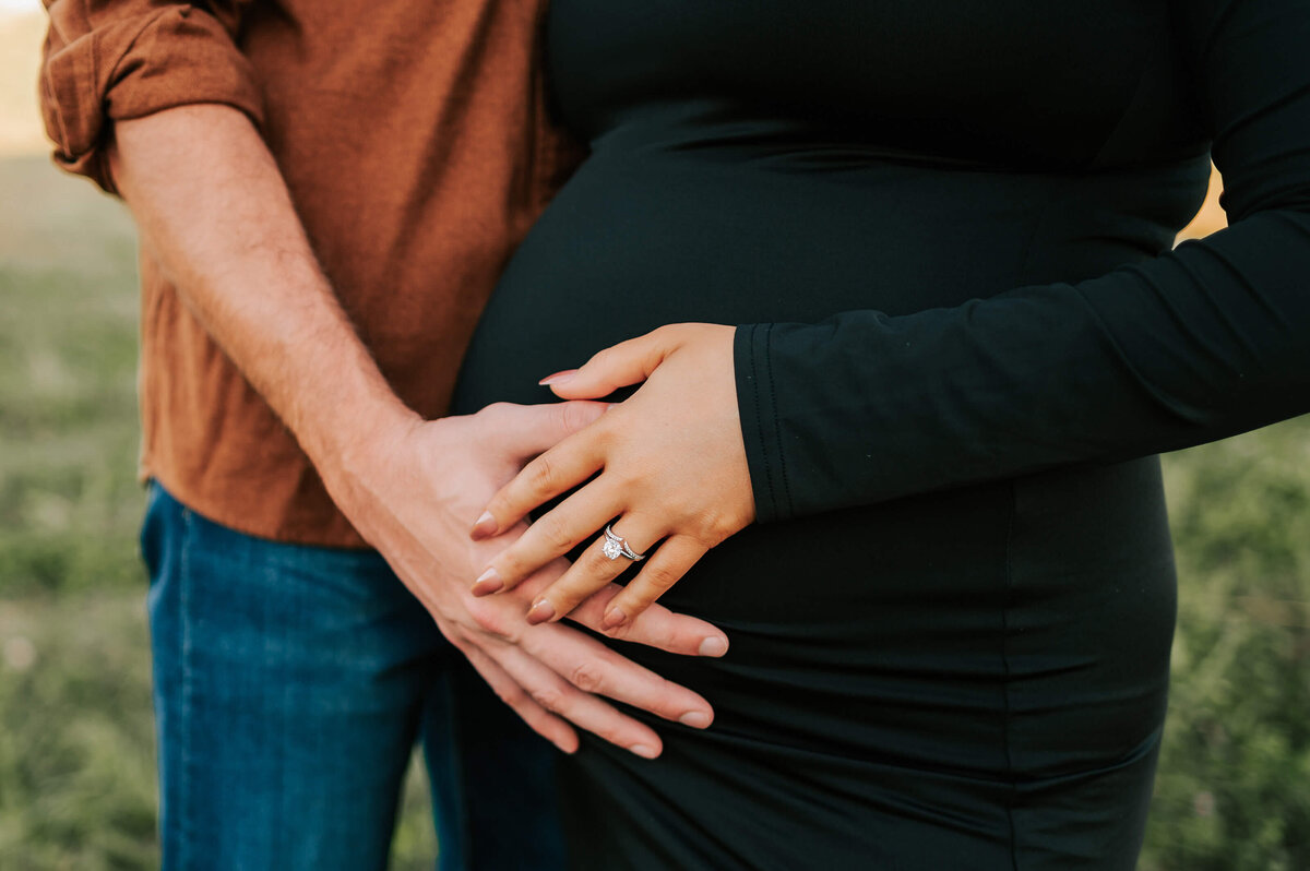 maternity picture in Springfield MO of close up of baby bump with parents hands