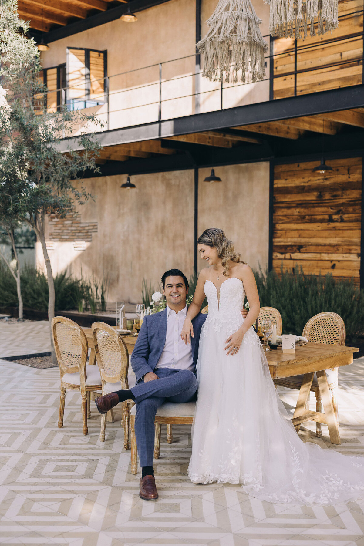 Rustic wedding bridal gown with groom wearing blue suit