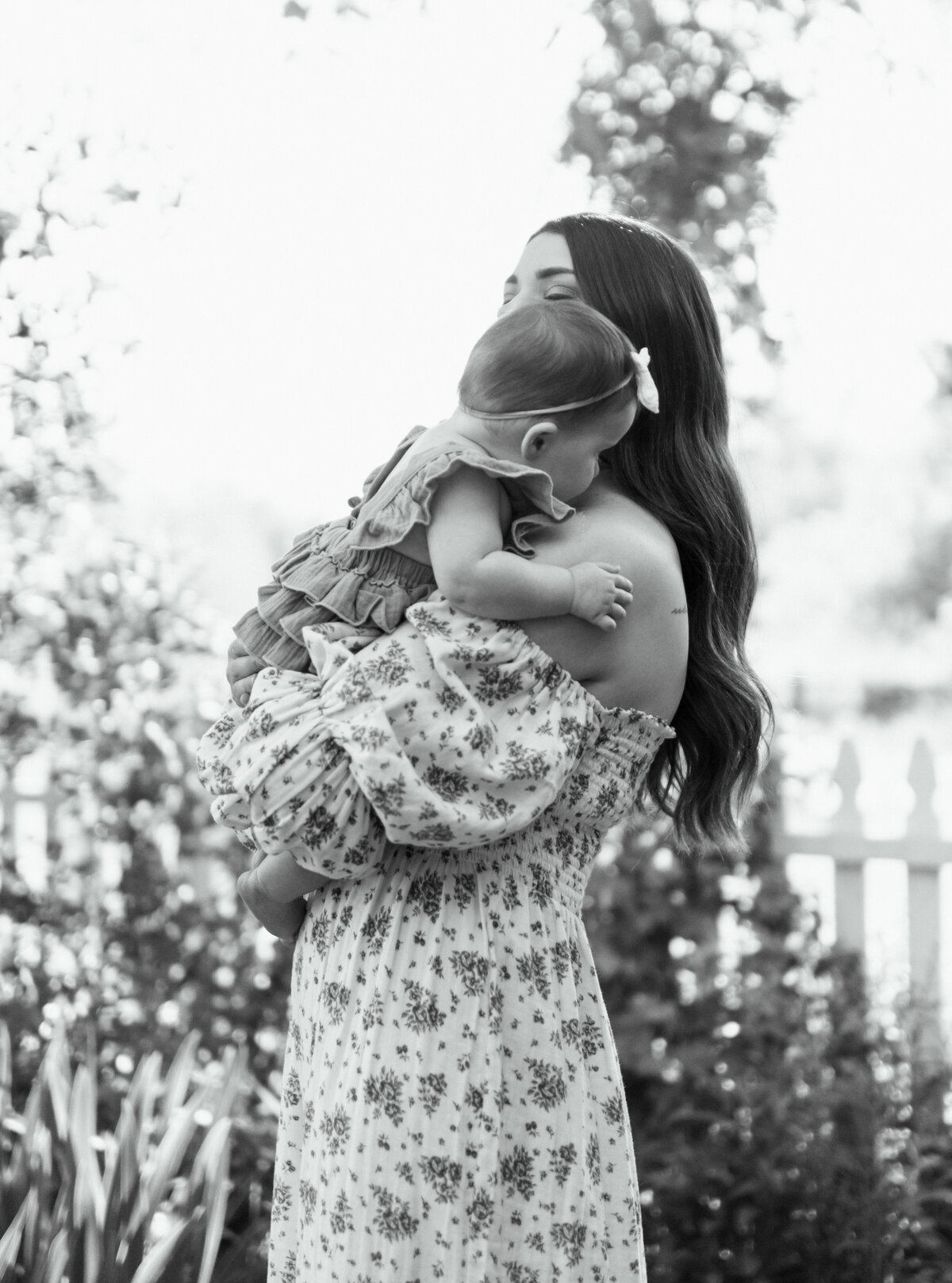 Black and white portrait of a mother holding her newborn close, highlighting the emotional connection, by Salt Lake City Family Photographer.
