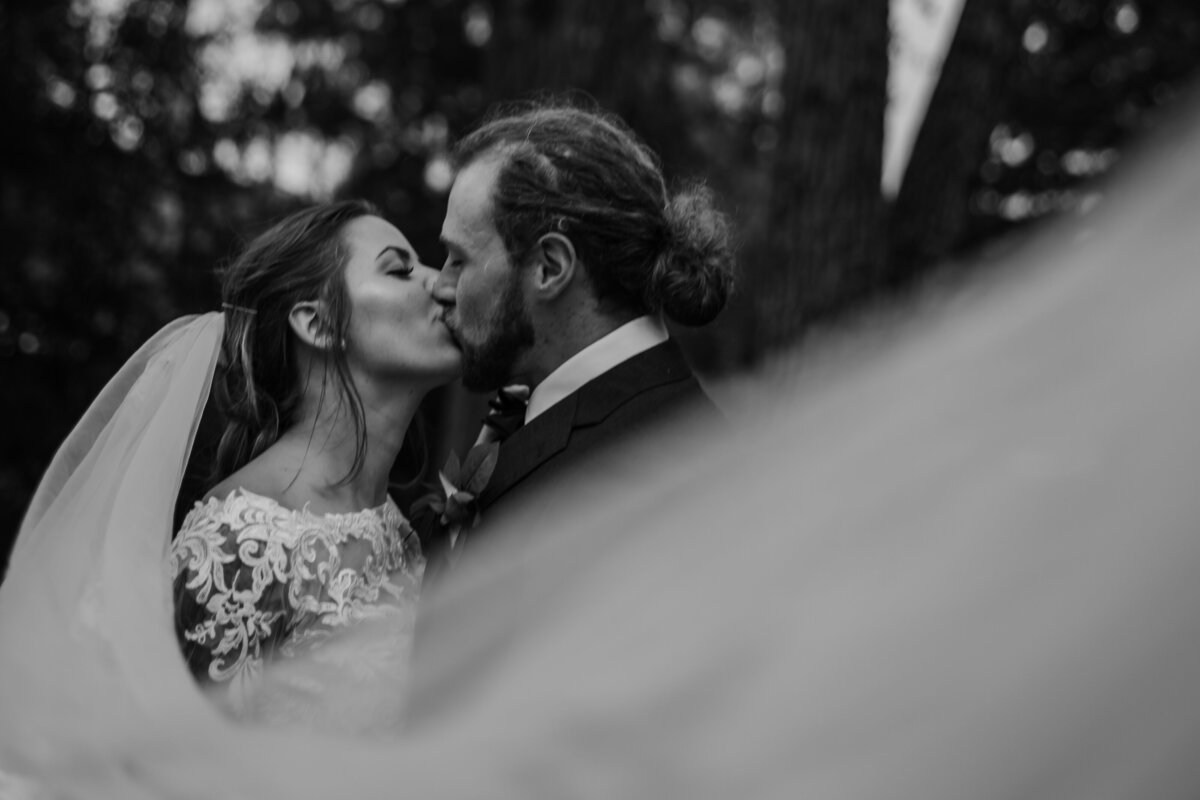 black and white photo married couple kissing