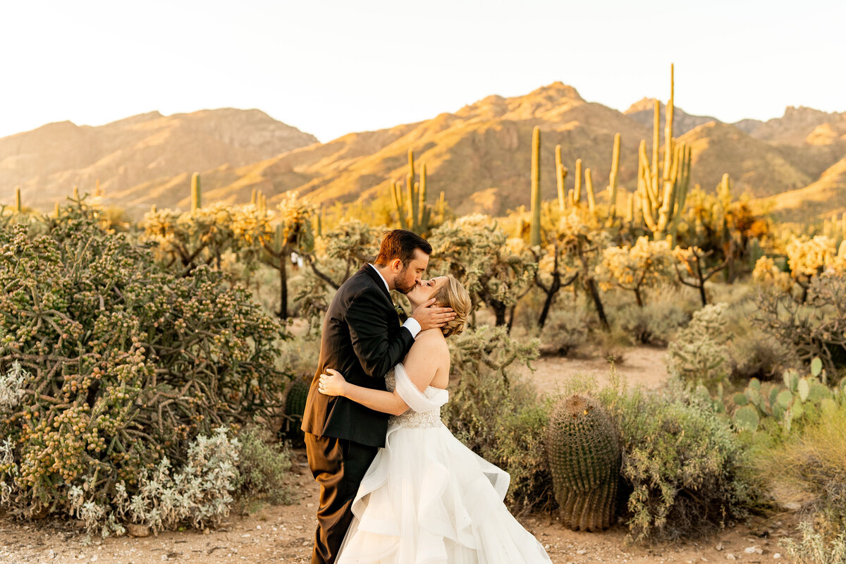 Sabino Canyon elopement couple kissing in desert in front of Mount Lemmon