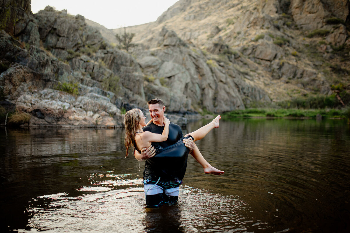 romantic photo of a couple in the water in the mountains of colorado.