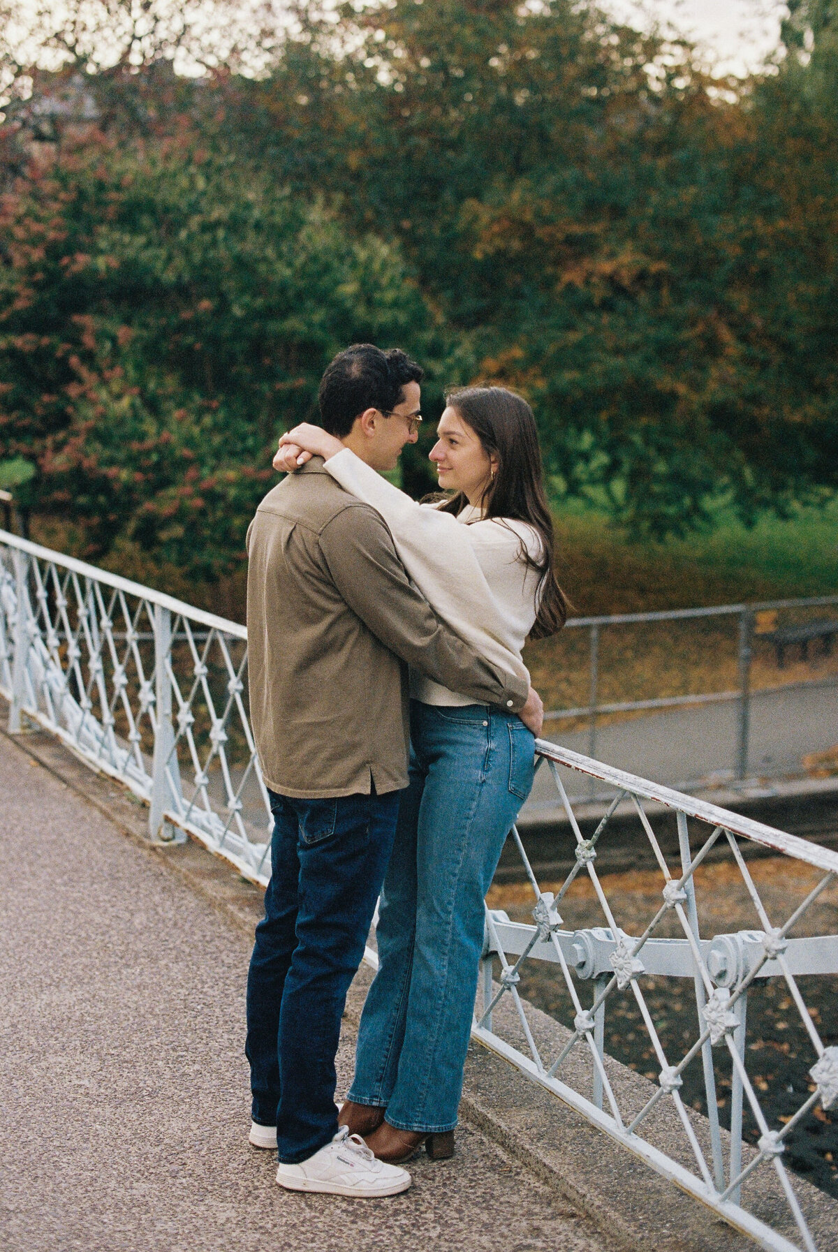 engaged couple on bridge