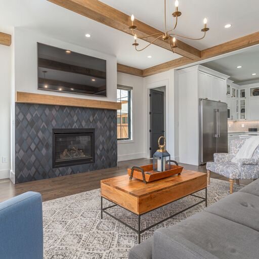 A living room with wood beams and a fireplace