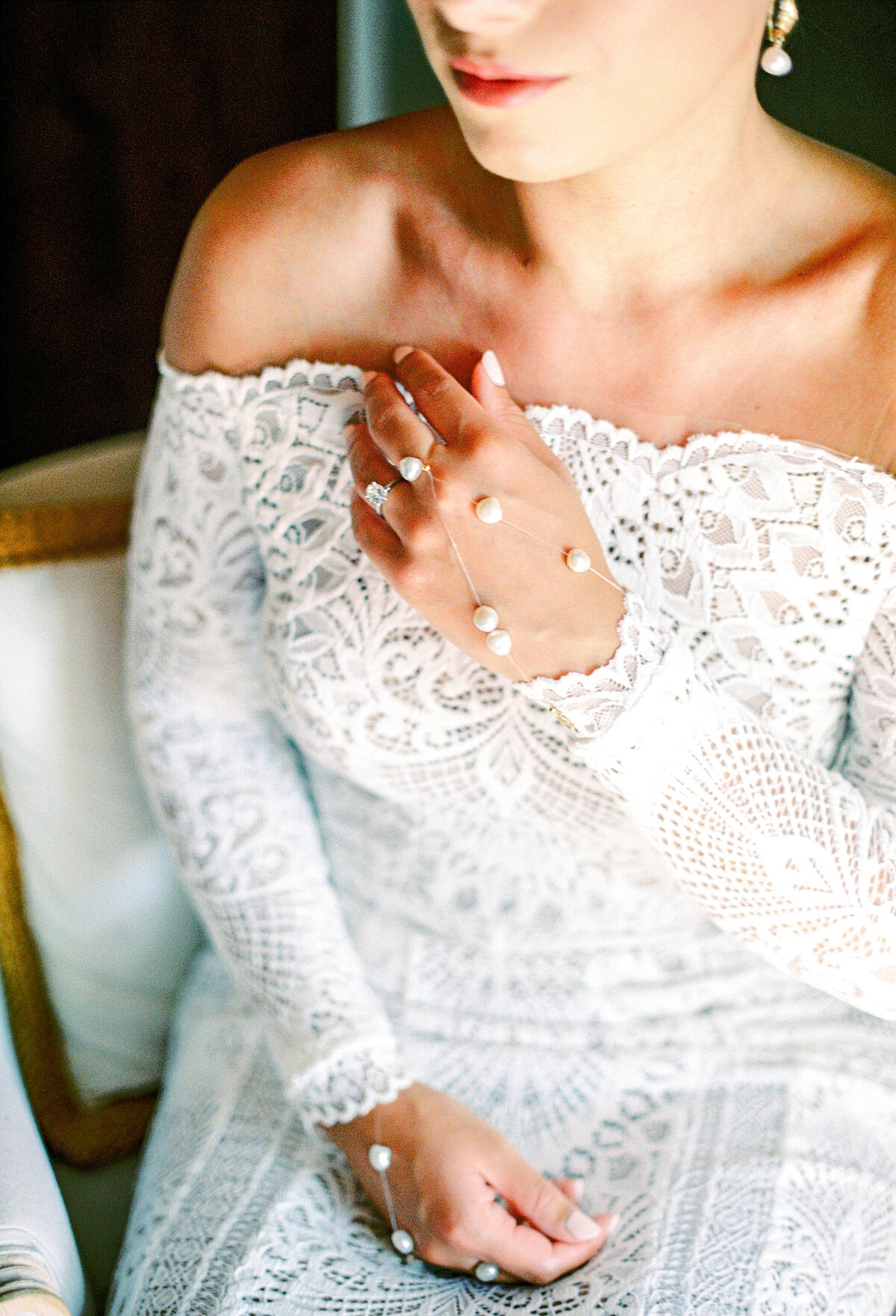 Film photograph of  bride in all lace wedding gown with pearl strings over hands photographed by Italy wedding photographer at Villa Montanare Tuscany wedding
