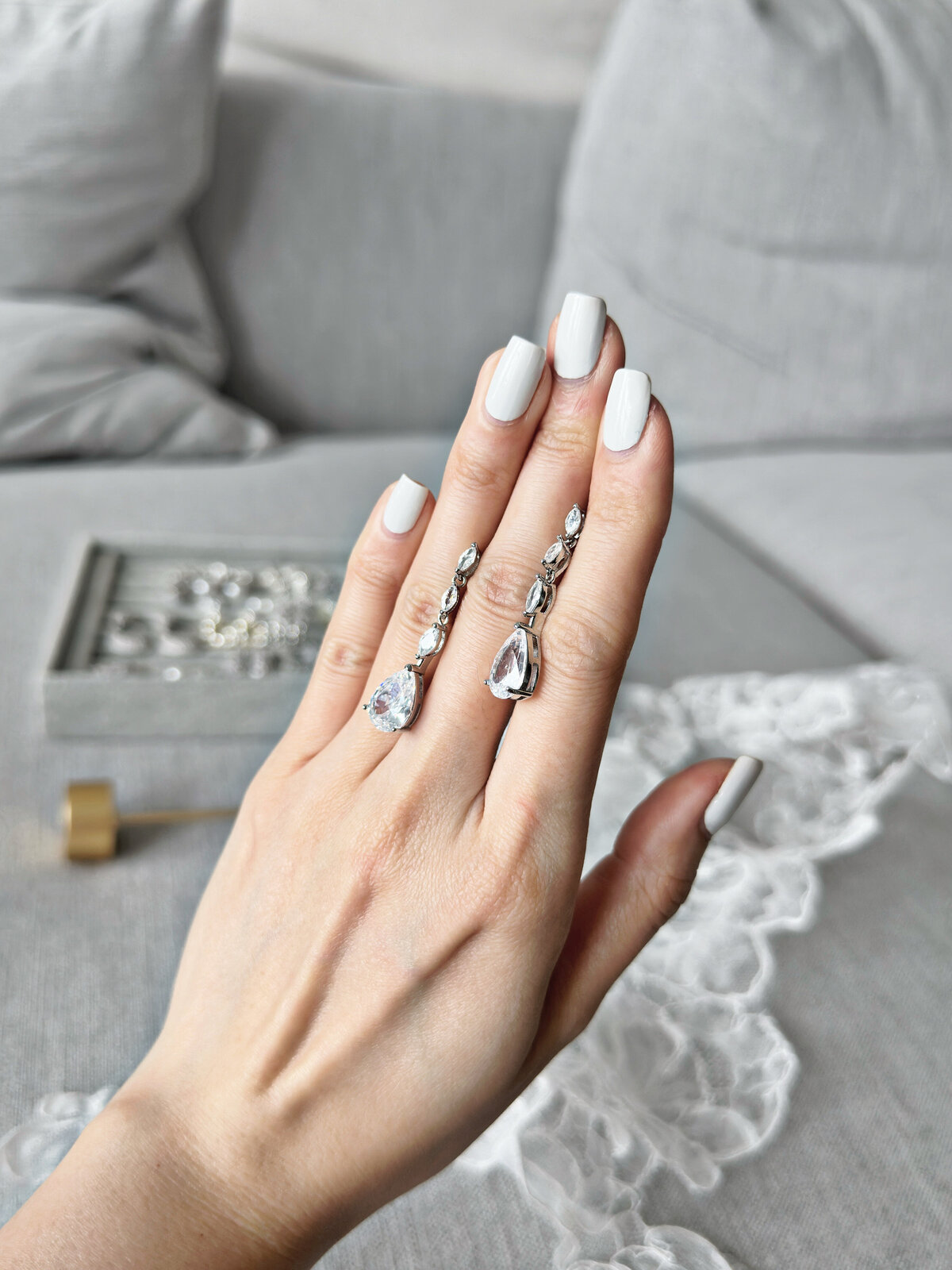 Bride wearing luxurious crystal and pearl accessories with graceful updo
