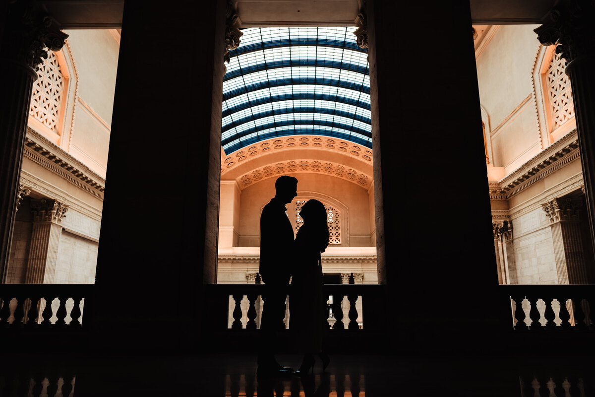 A couple embrace in front of Chicago Union Station