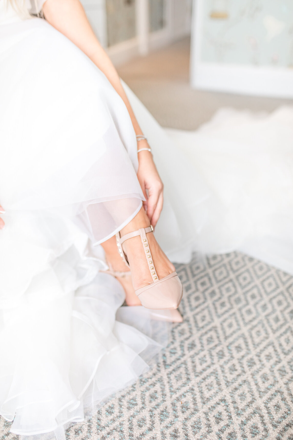 Close up of bride putting on shoes
