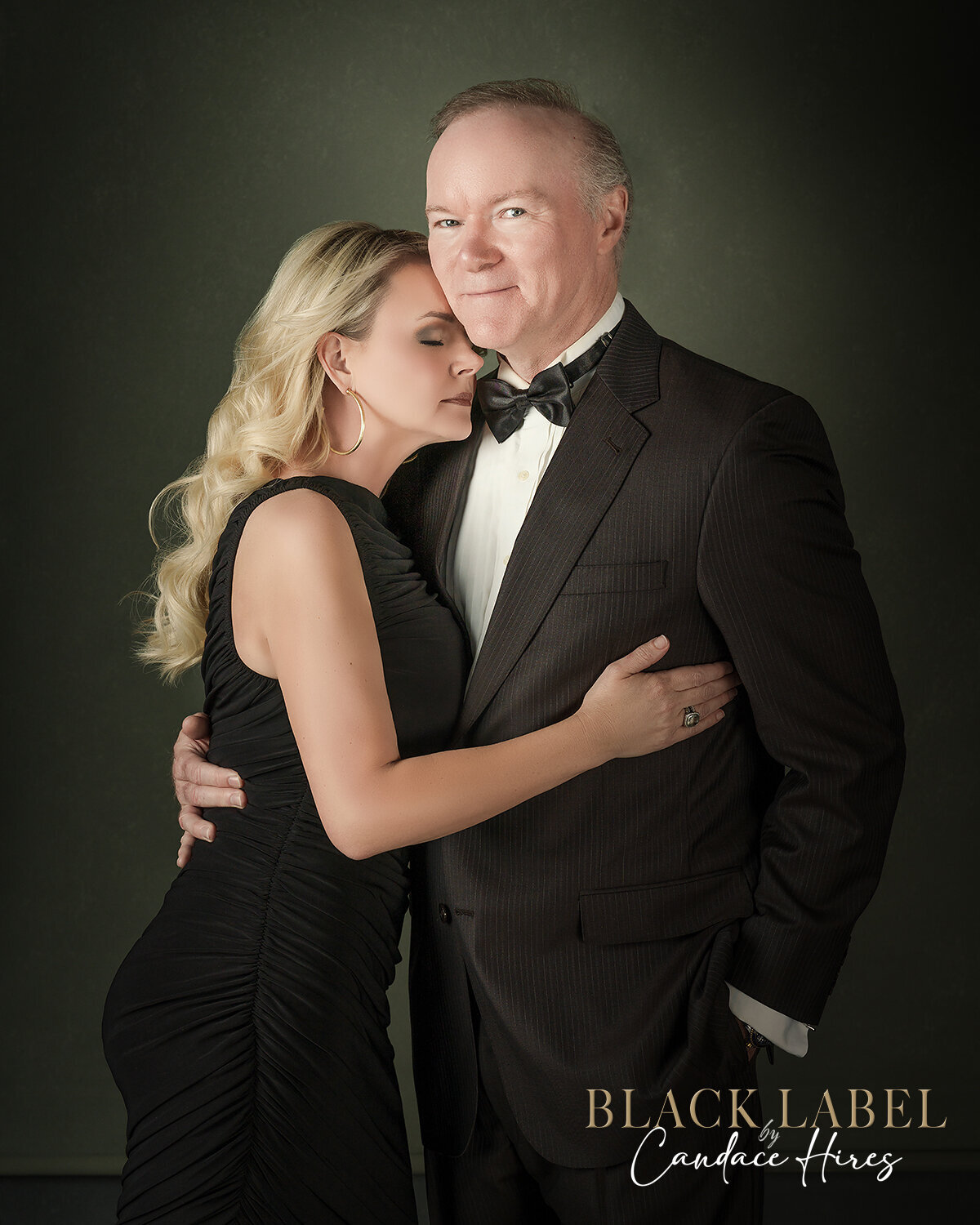 husband and wife photographed in black ball gown and black tuxedo in studio