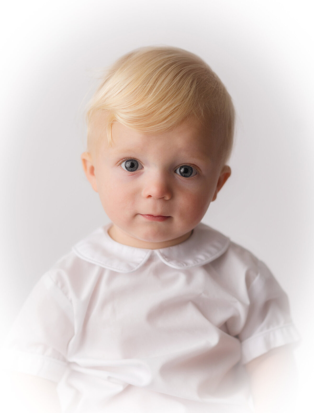 Baby peers into the camera during Heirloom Portrait Photoshoot in Charleston.