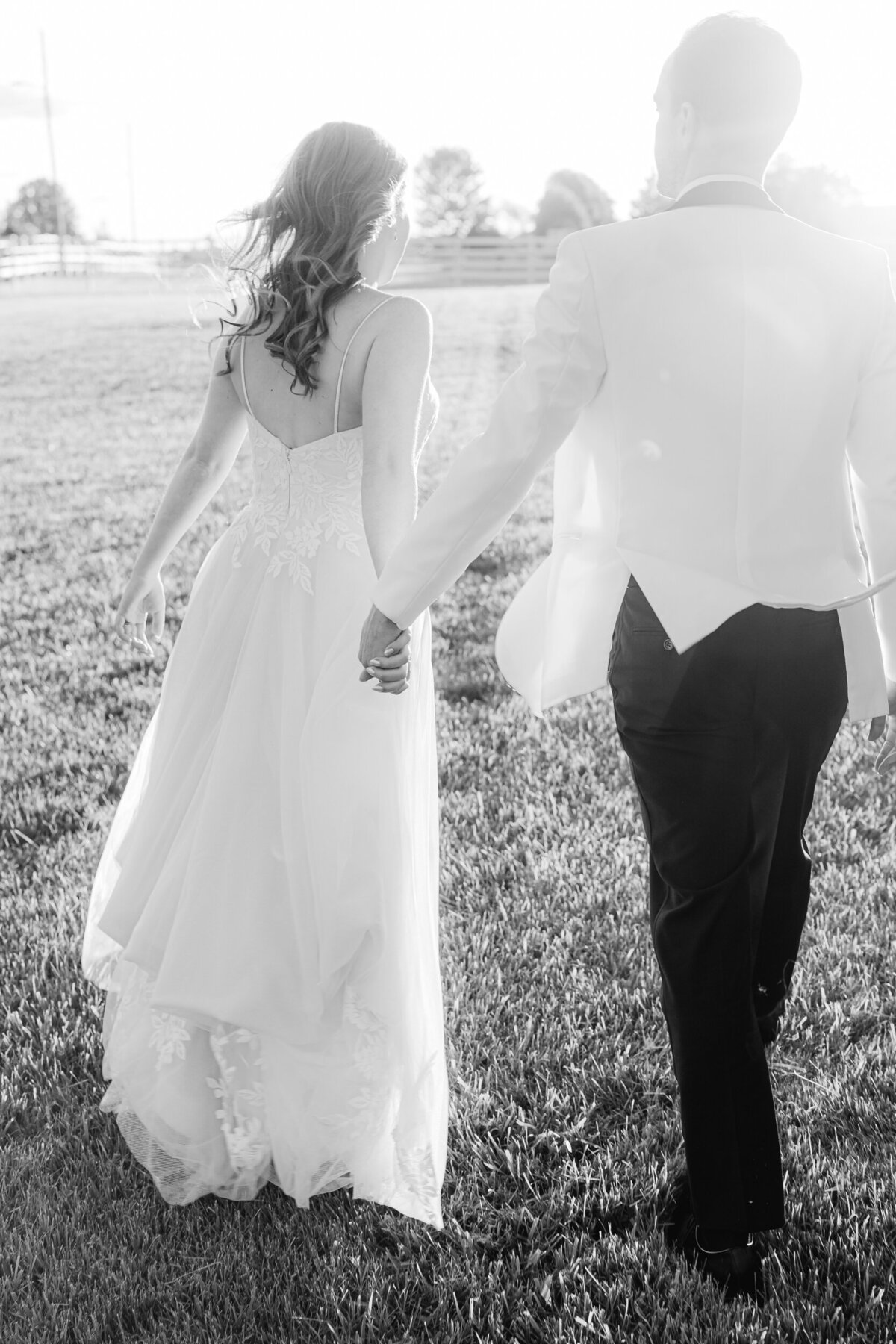 bride and groom walking into the sunset at Alum Creek Farm wedding venue in Columbus Ohio