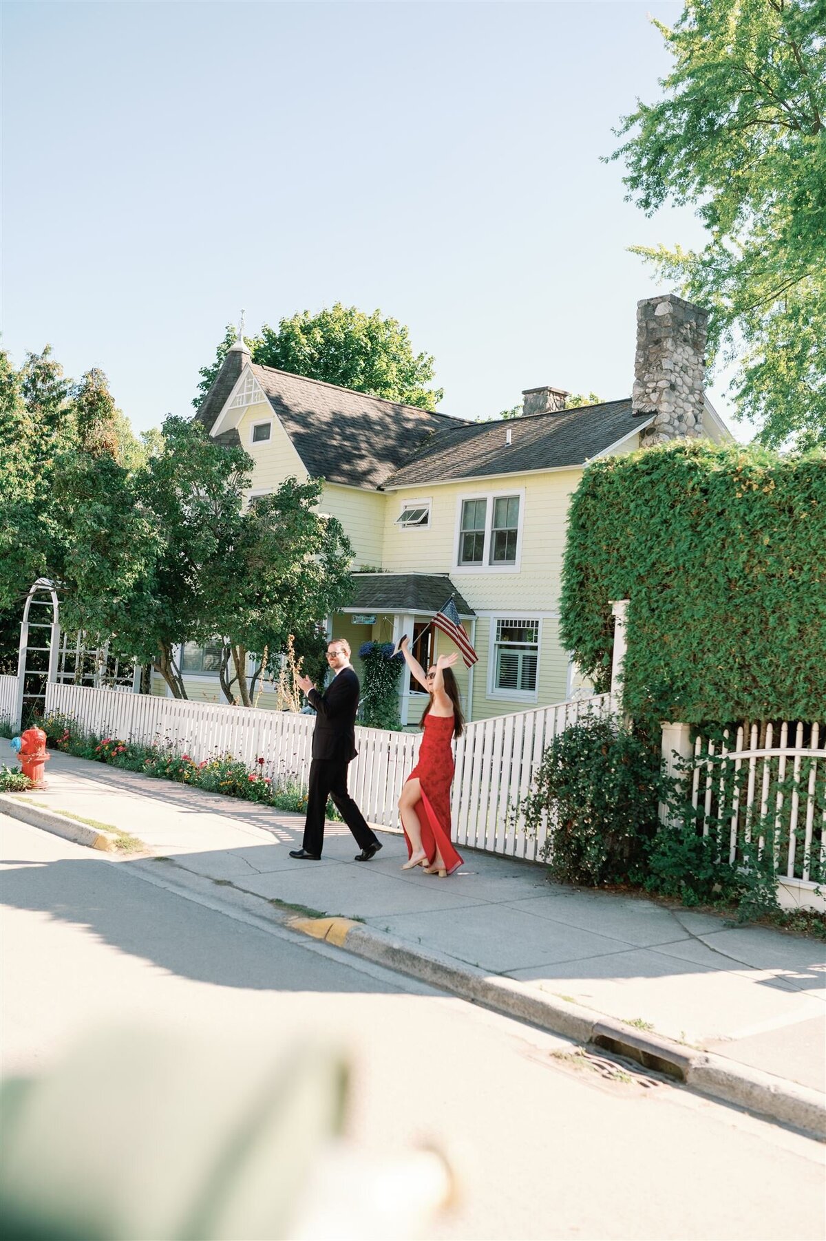 Guests waving to the bride and groom during their Mackinac Island wedding